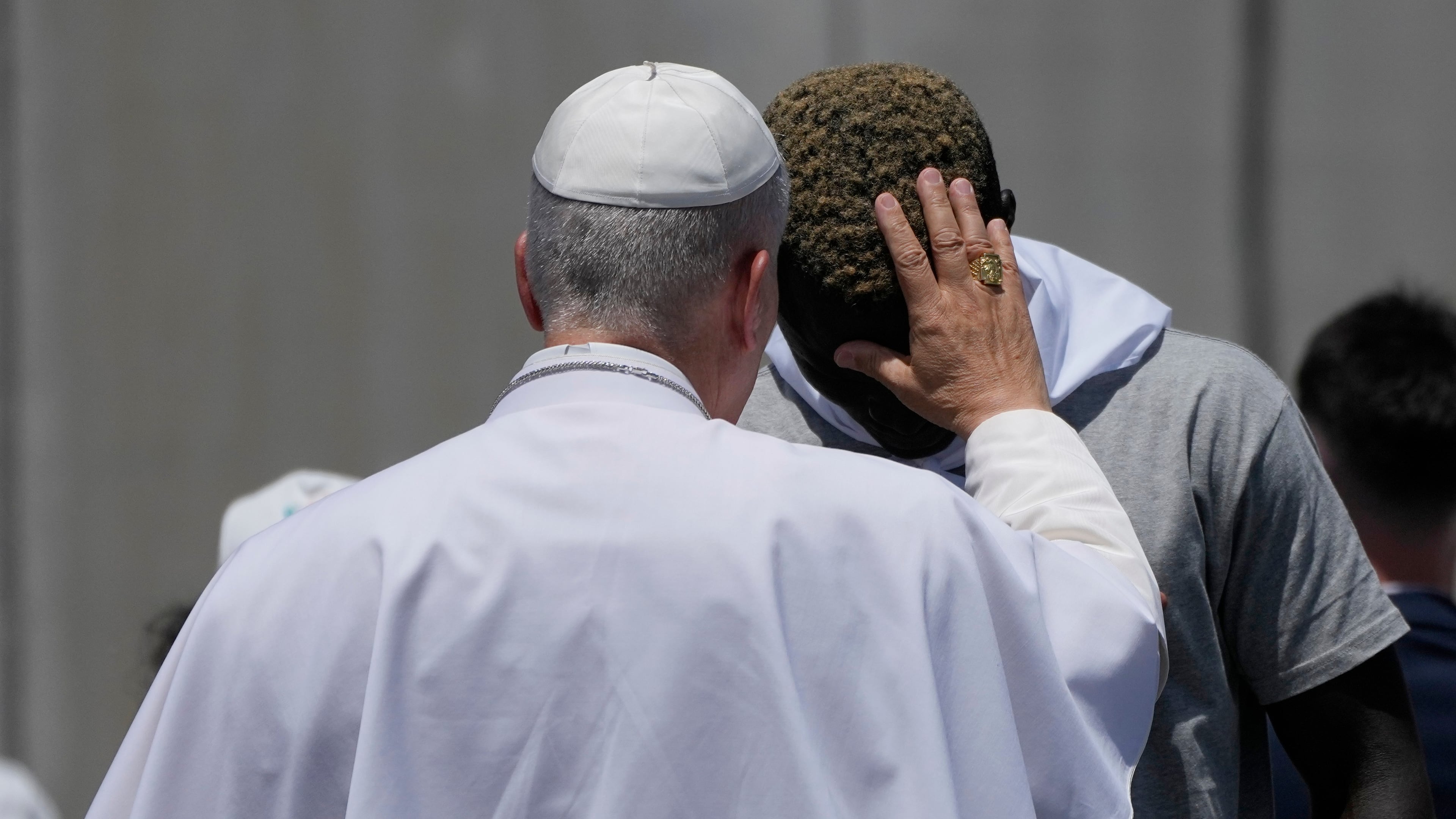 Pope Leo XIV blesses a migrant during a meeting with organisations working with migrants in Arguineguin at the Canary Islands, Spain, Thursday, June 11, 2026. (AP Photo/Alessandra Tarantino)