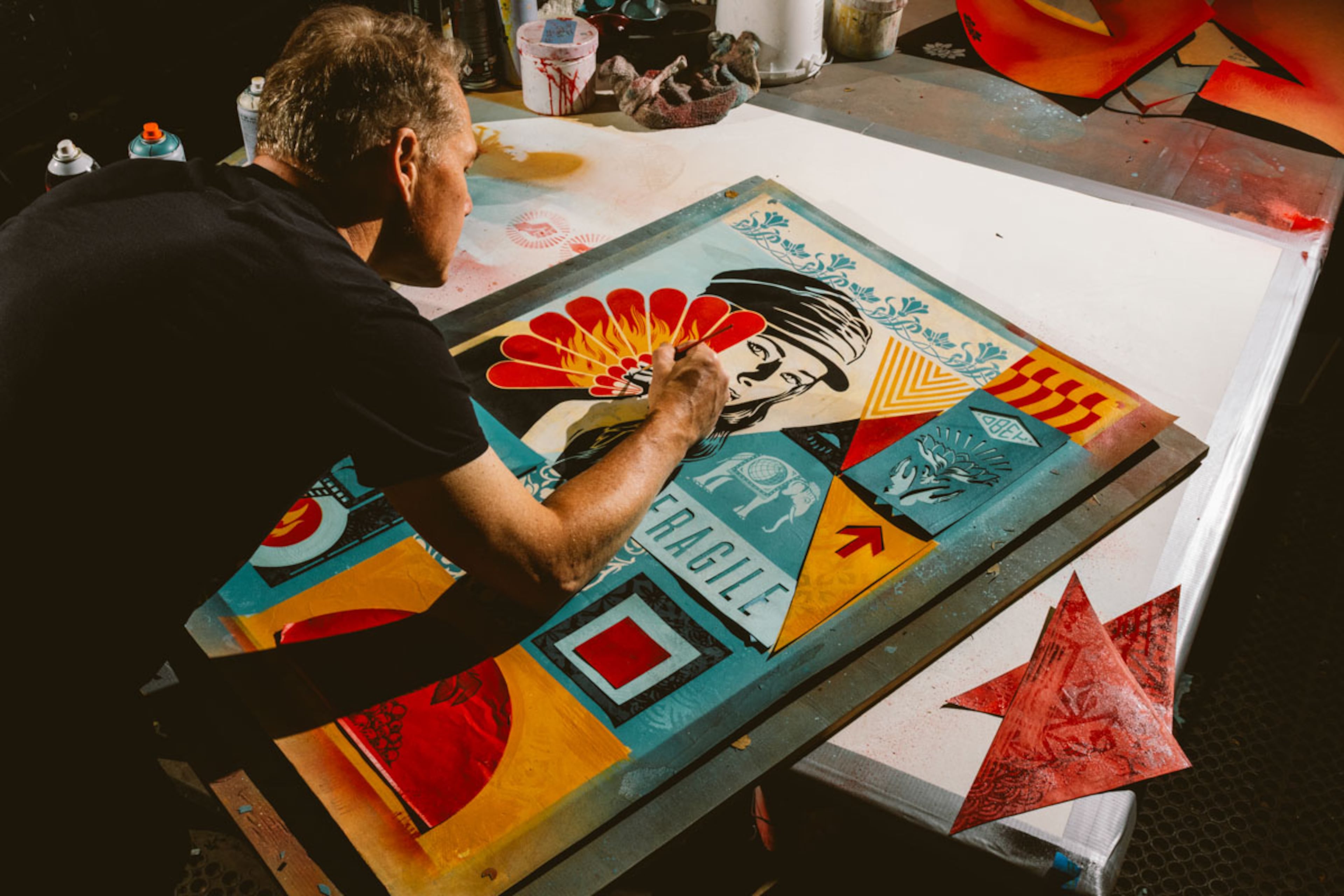 Shepard Fairey at work on a colorful artwork created in the bold, graphic style for which he has become famous. (Courtesy of ABV Gallery)