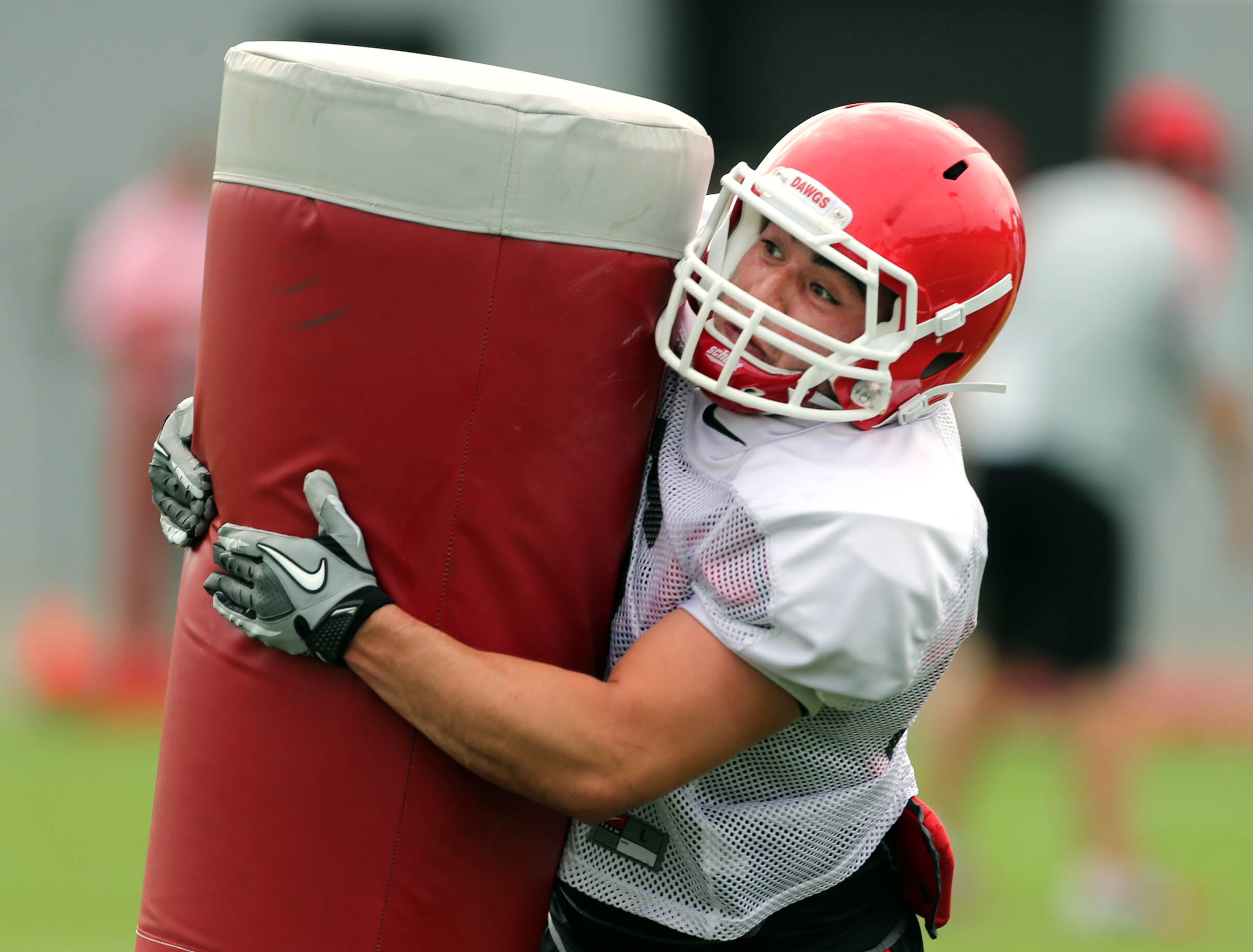 University of Georgia strong safety Devin Gillespie (36) hits a sled during preseason football practice at the University of Georgia Thursday afternoon in Athens, Ga., August 15, 2013. JASON GETZ / JGETZ@AJC.COM
