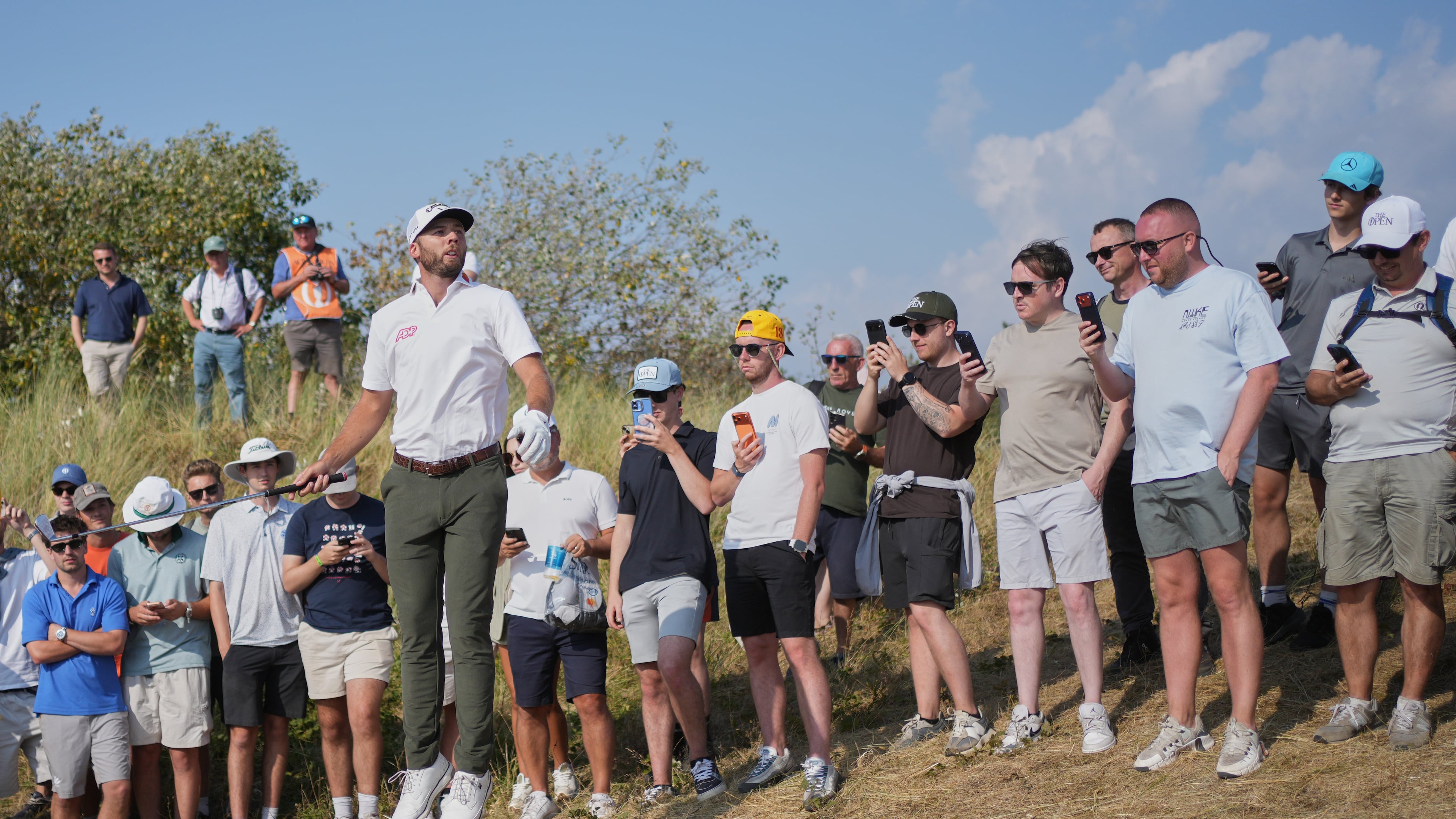 Sam Burns jumps up to try and see the pin on the 9th hole during the third day of the British Open Golf championships at Royal Birkdale golf club, in Southport, England, Saturday, July 18, 2026. (AP Photo/Jon Super)