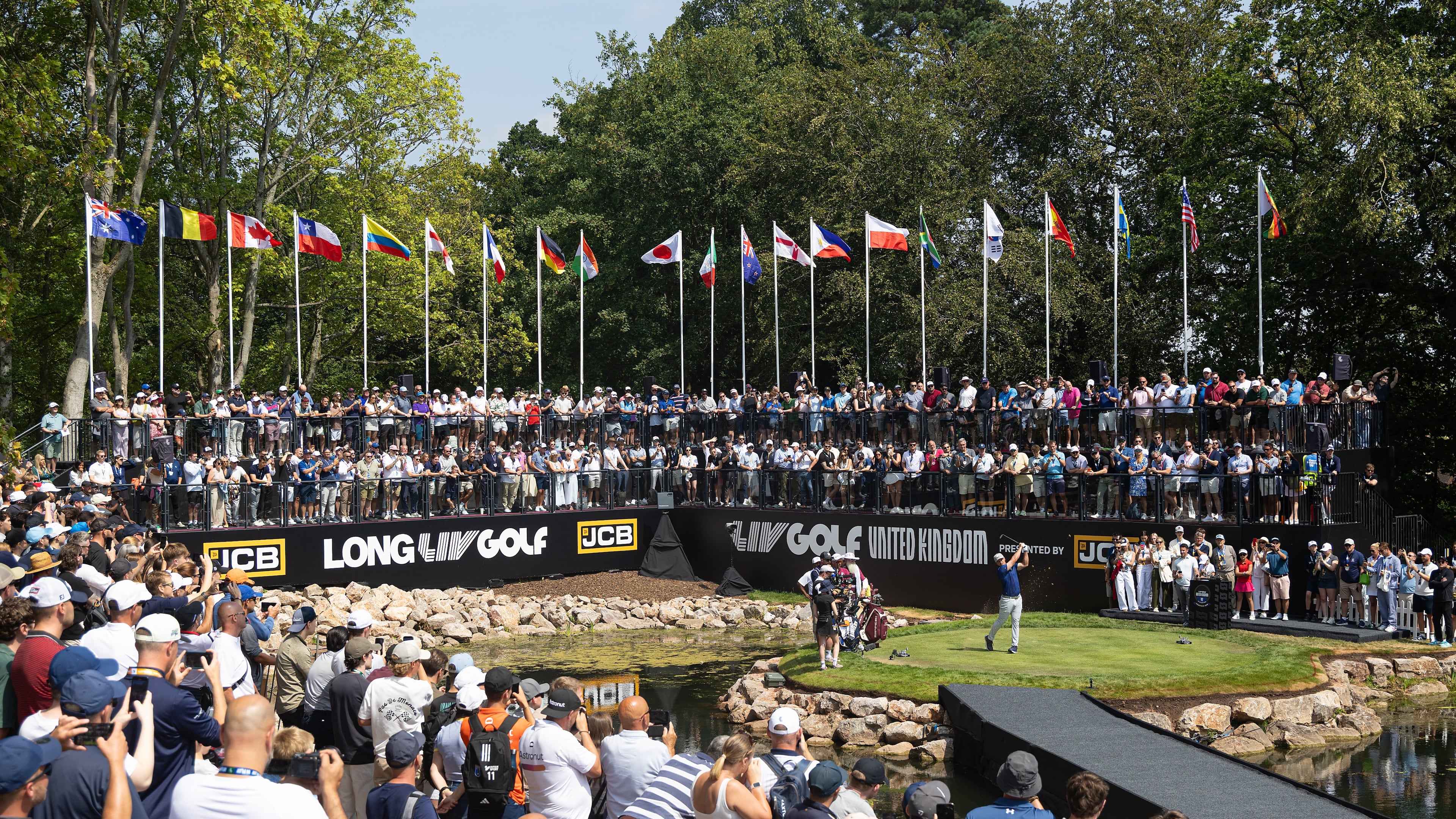 Captain Bryson DeChambeau, center right, of Crushers GC hits from the first tee during the second round of LIV Golf United Kingdom, Friday, July 24, 2026, in Rocester, England. (Chris Trotman/LIV Golf via AP)