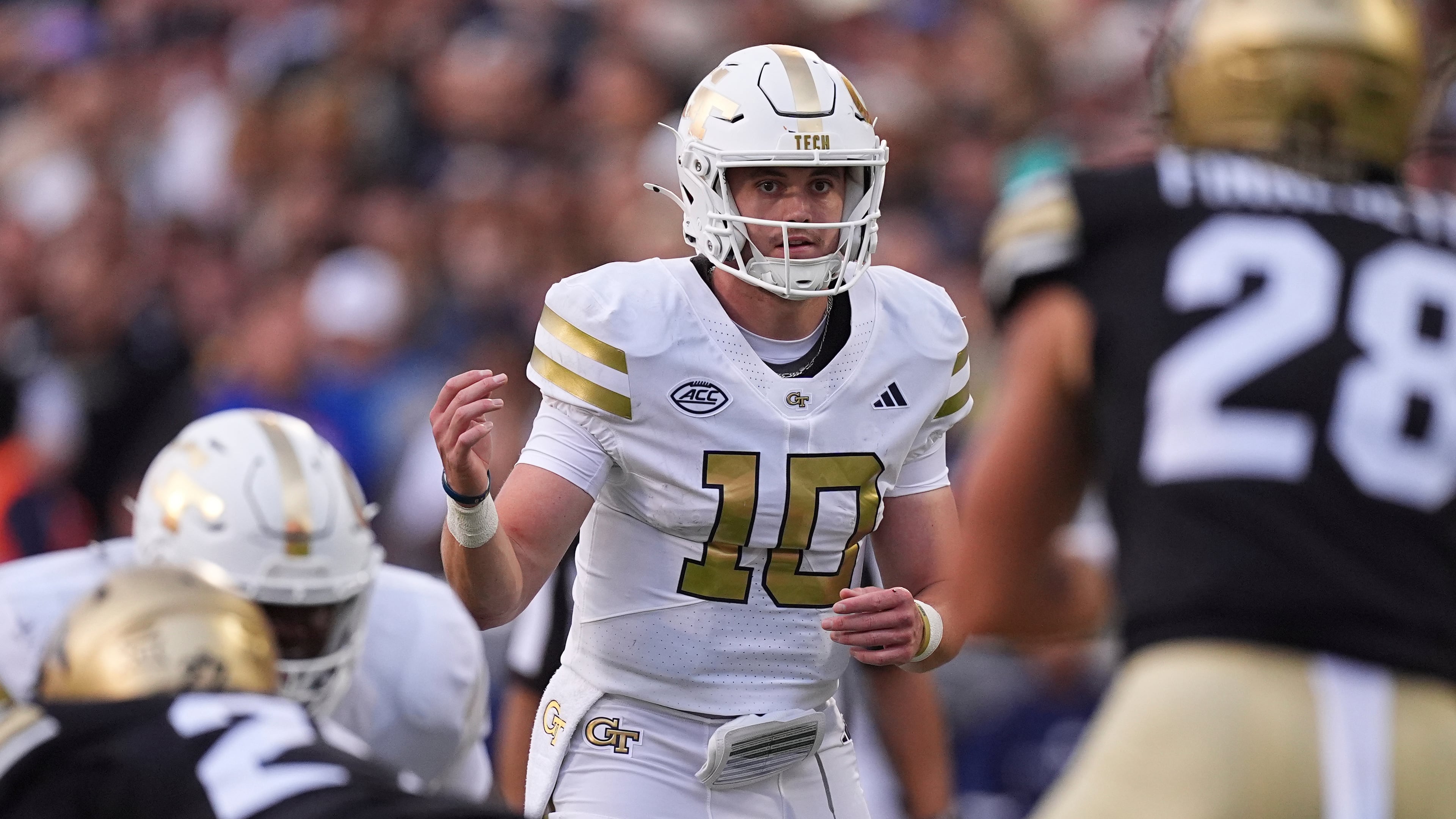 Georgia Tech quarterback Haynes King calls a play at the line of scrimmage on Friday, Aug. 29, 2025, in Boulder, Colo. With the Colorado defense biting hard on his feint, King had the opening he needed to squeeze through the defensive line, break into the clear and run for the Yellow Jackets’ game-winning touchdown, a 45-yard dash. (David Zalubowski/AP)