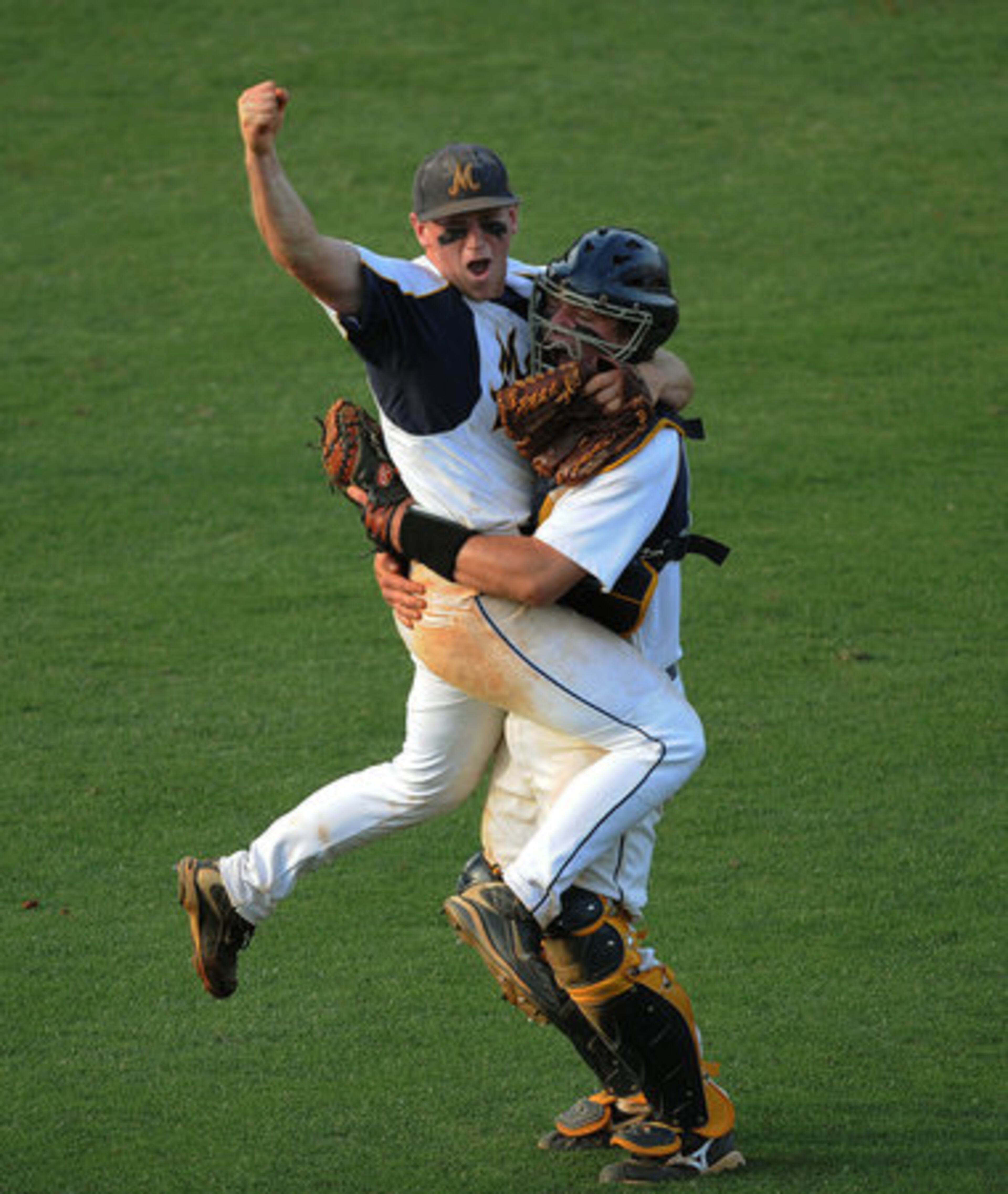 Marist pitcher David Bourbonnais jumps in the arms of catcher Charlie Mathes after winning the GHSA Class AAAA baseball state championship over Whitewater.