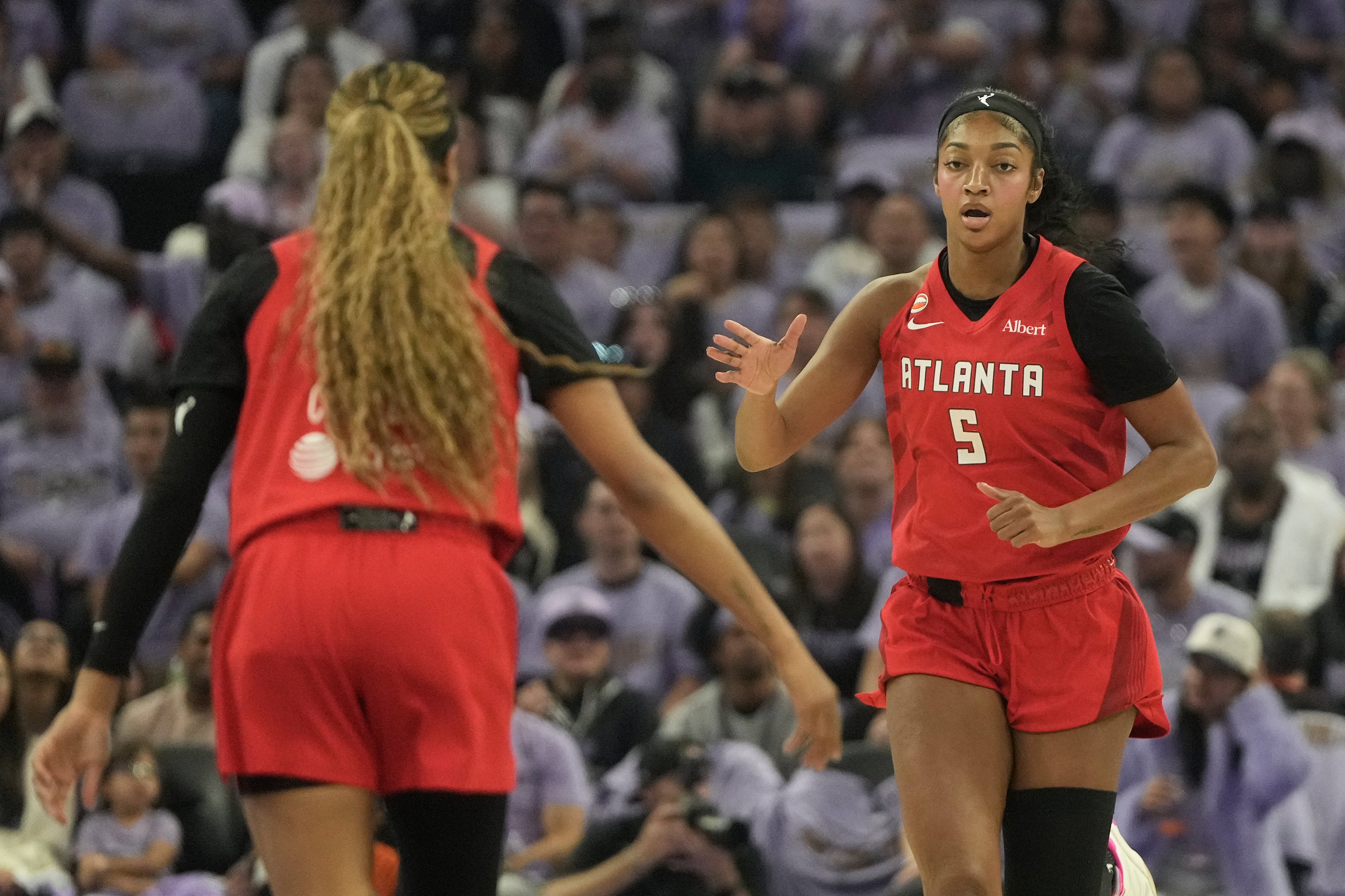 Atlanta Dream forward Angel Reese (5) is congratulated by guard Jordin Canada after scoring against the Golden State Valkyries during the first half of Game 1 of the WNBA basketball finals, Saturday, Oct. 17, 2026, in San Francisco. (AP Photo/Jeff Chiu)