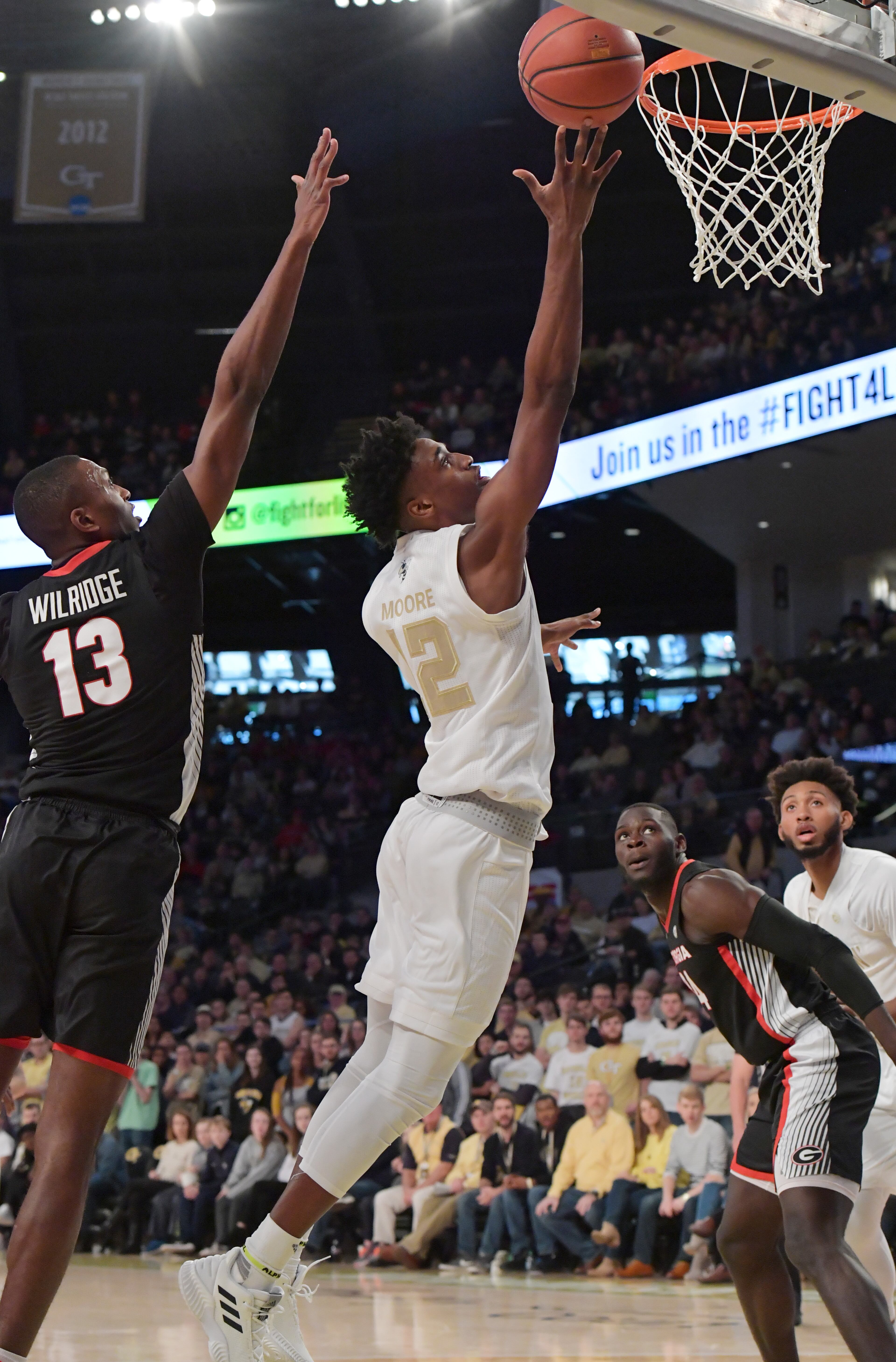 Georgia Tech forward Khalid Moore (12) goes up for the shot past Georgia forward E'Torrion Wilridge (13) in the first half of Saturday's game. (Hyosub Shin/hshin@ajc.com)