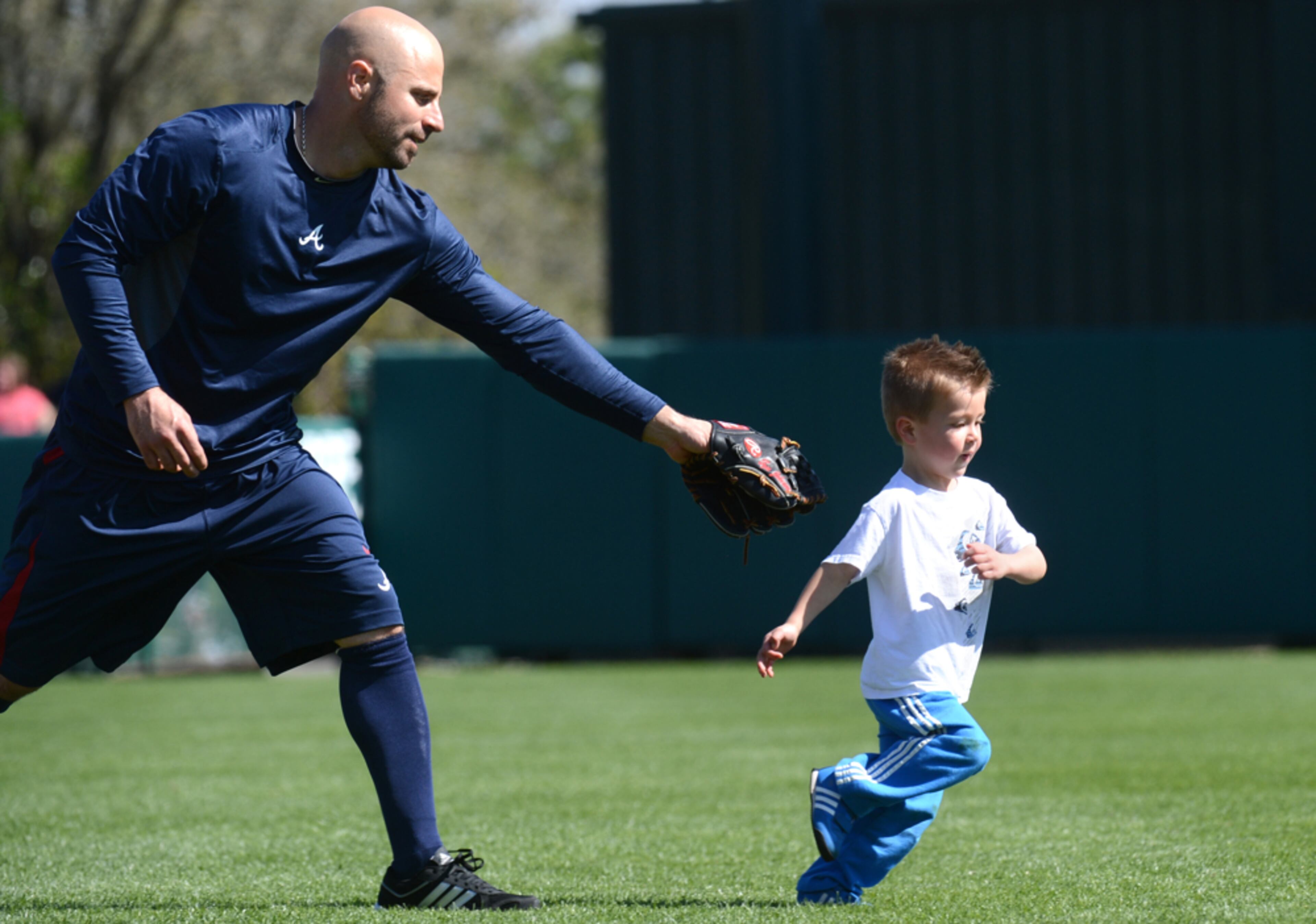 CAN'T CATCH ME--February 18, 2013 Lake Buena Vista, Fl: Atlanta Braves outfielder Reed Johnson plays baseball with his 3-year-old son Tyce after the fourth full squad workout at Champion Stadium in the ESPN Wide World of Sports Complex in Lake Buena Vista, Fl., on Monday, Feb. 18, 2013. HYOSUB SHIN / HSHIN@AJC.COM