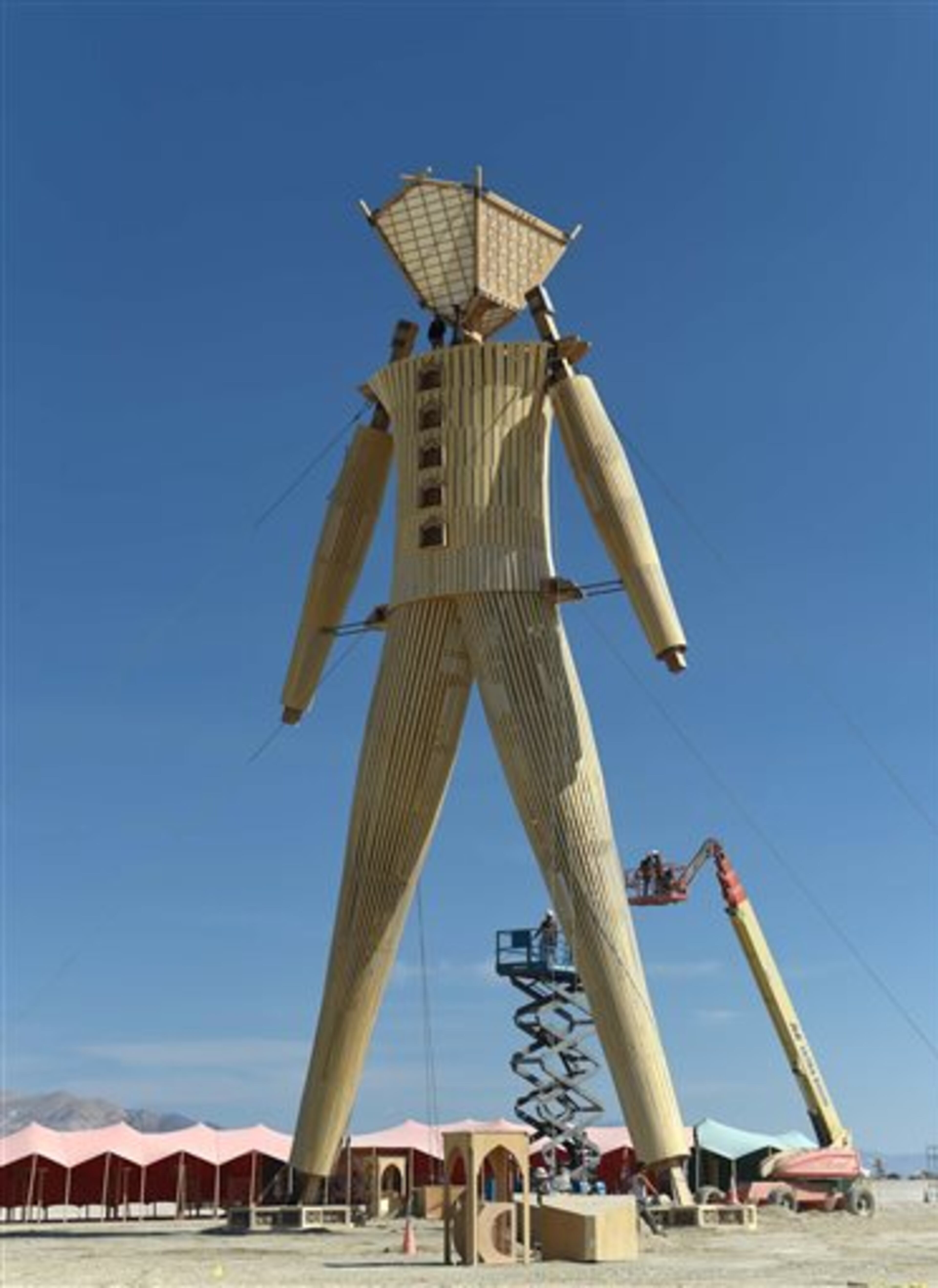Artists and volunteers work on the "Man" at the annual Burning Man event on the Black Rock Desert in Gerlach, Nev., on Aug. 24, 2014, a day before the event opens to ticket holders. (AP Photo/Reno Gazette-Journal, Andy Barron) NO SALES; NEVADA APPEAL OUT; SOUTH RENO WEEKLY OUT