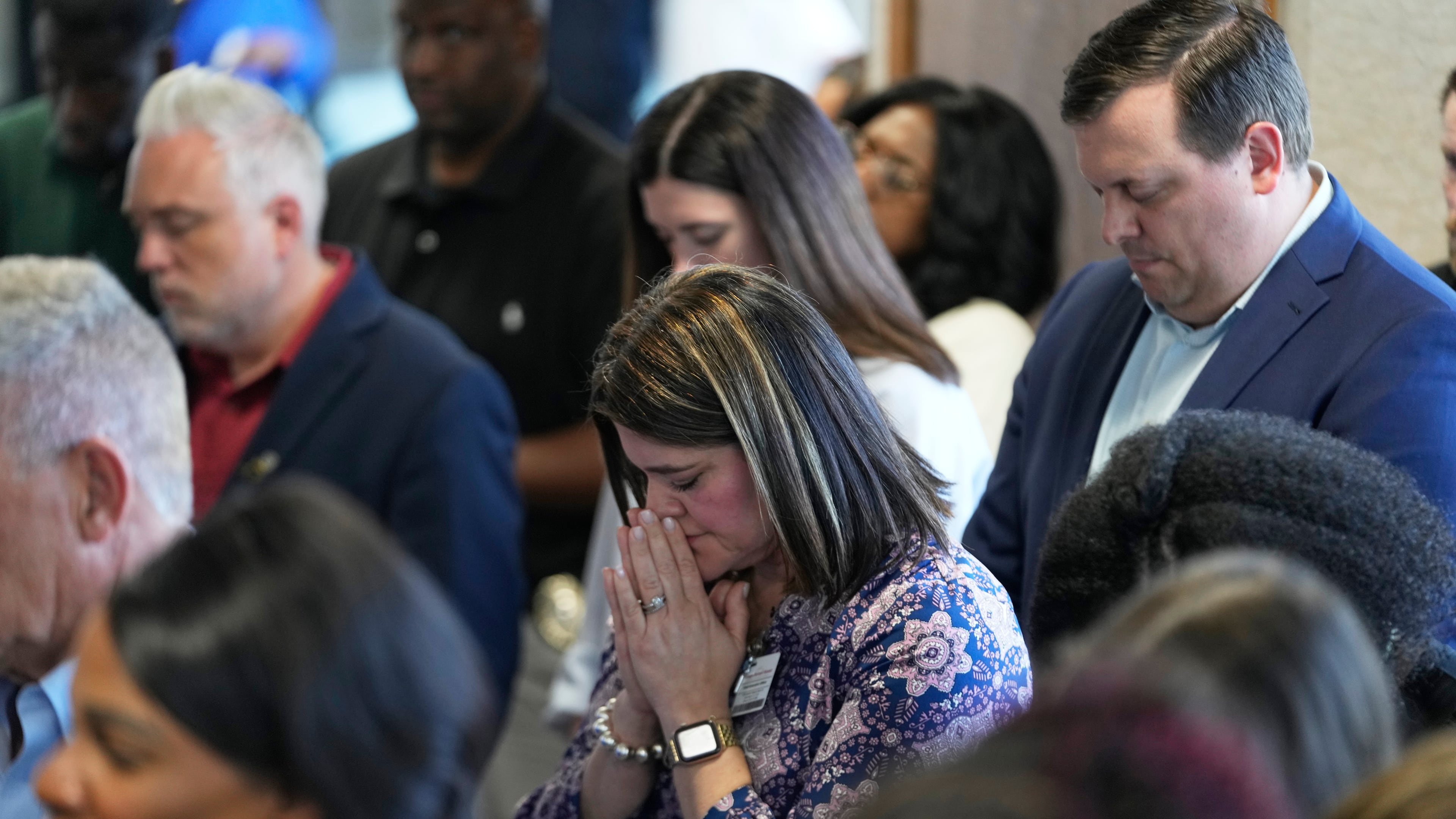 Attendees pray at the conclusion of a news conference about the children killed during a mass shooting the day before in Shreveport, La., Monday, April 20, 2026. (AP Photo/Gerald Herbert)