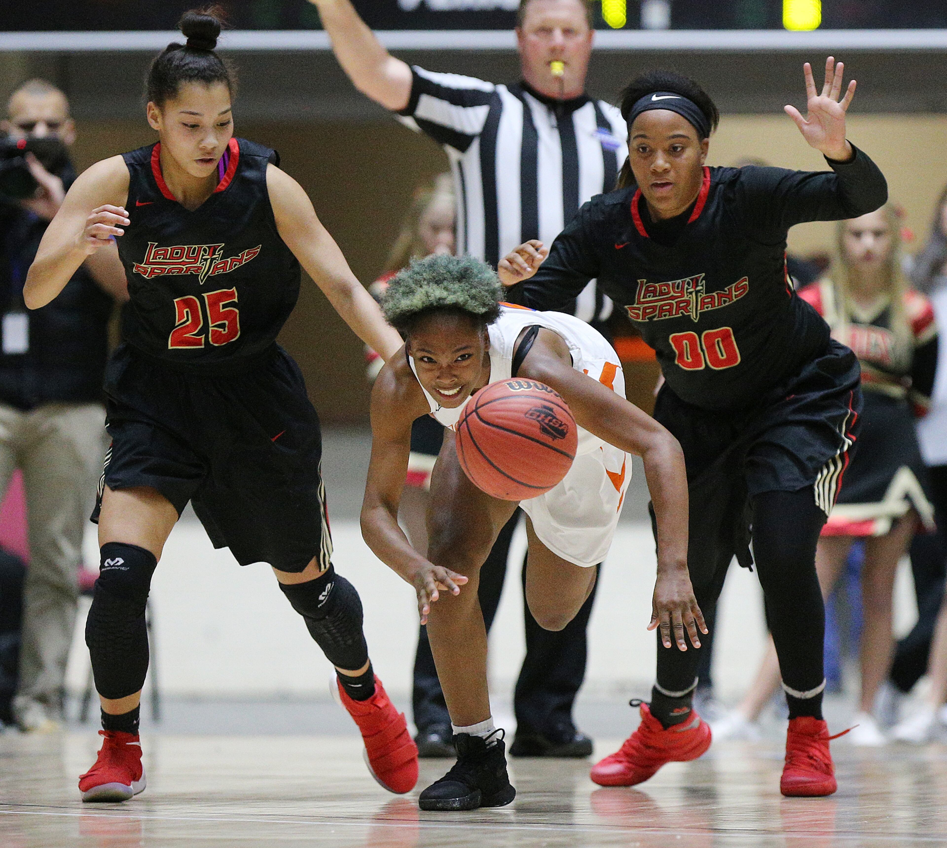 March 8, 2018 Macon: Johnson-Savannah guard Alana Boone comes away with the ball for against GAC forward Maya Timberlake and Caria Reynolds in their GHSA state basketball championship game on Thursday, March 8, 2018, in Macon. Curtis Compton/ccompton@ajc.com