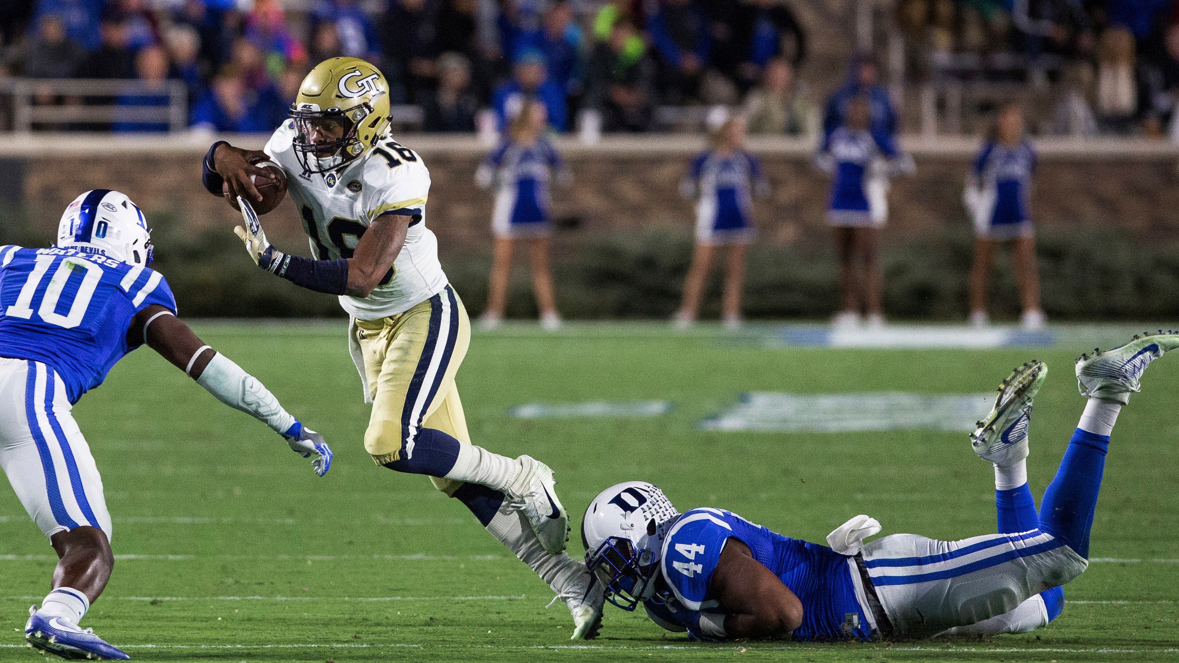 Georgia Tech quarterback TaQuon Marshall (16) carries the ball between the defense of Duke's Marquis Waters (10) and Joe Giles-Harris (44) during the second half of an NCAA college football game in Durham, N.C., Saturday, Nov. 18, 2017. Duke beat Georgia Tech 43-20. (AP Photo/Ben McKeown)