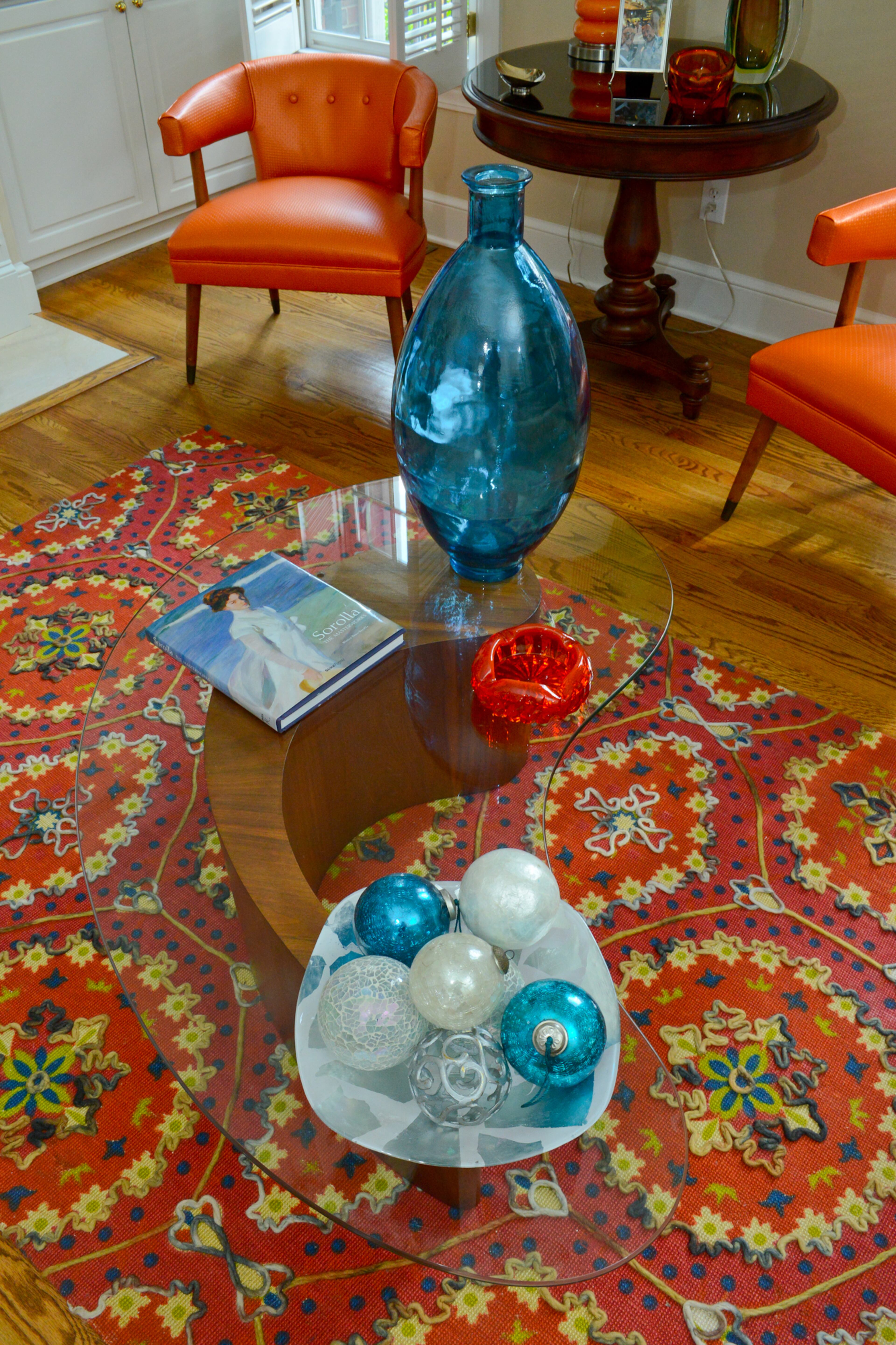 Homeowners Pedro Ayestaran Diaz and Jeffrey Chandler purchased their 1960s comma-shaped coffee table, made of wood and glass by Vladimir Kagan, from Peter Pero at Antique Factory in Chamblee.