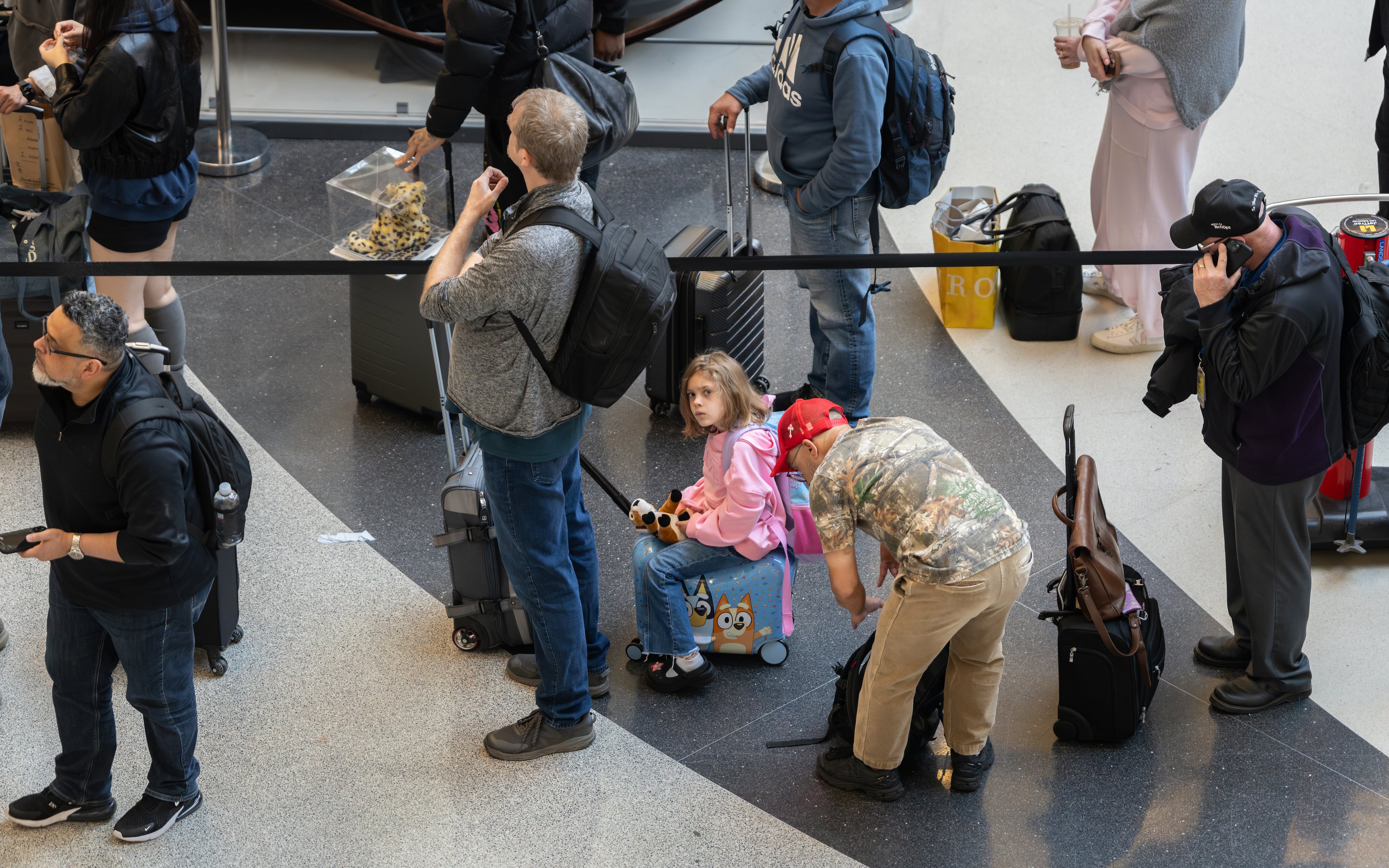 Travelers wait in multihour lines Friday for domestic security at Hartsfield-Jackson Atlanta International Airport amid the ongoing partial goverment shutdown. (Ben Hendren for the AJC)