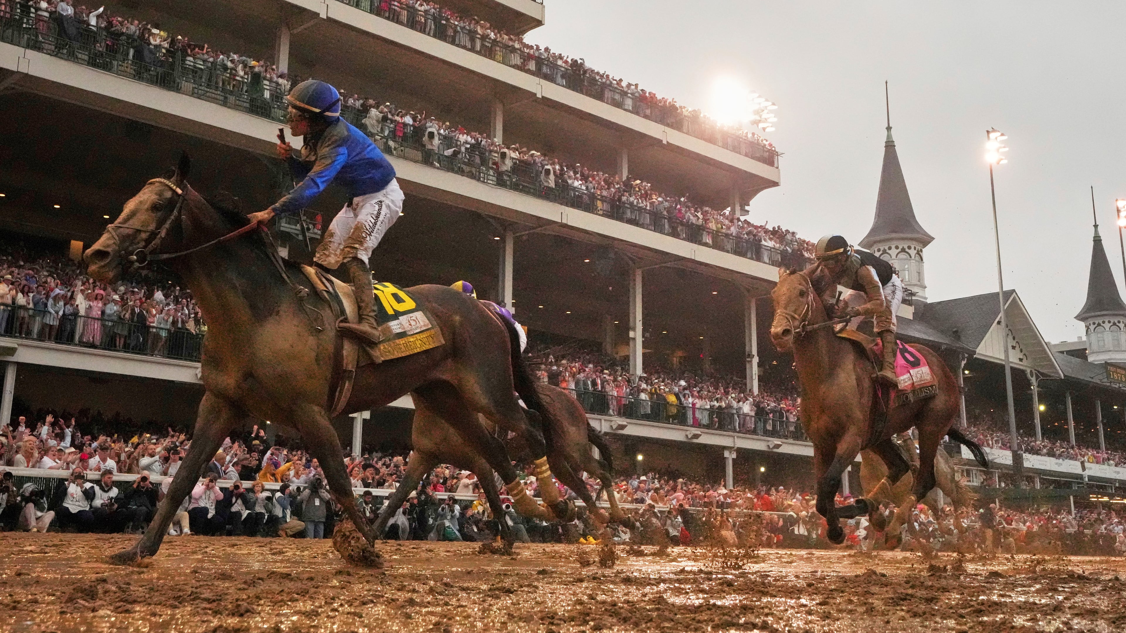 FILE - Sovereignty, ridden by Junior Alvarado, left, crosses the finish line to win the 151st running of the Kentucky Derby horse race followed by Journalism, ridden by Umberto Rispoli, May 3, 2025, at Churchill Downs in Louisville, Ky. (AP Photo/Abbie Parr, File)