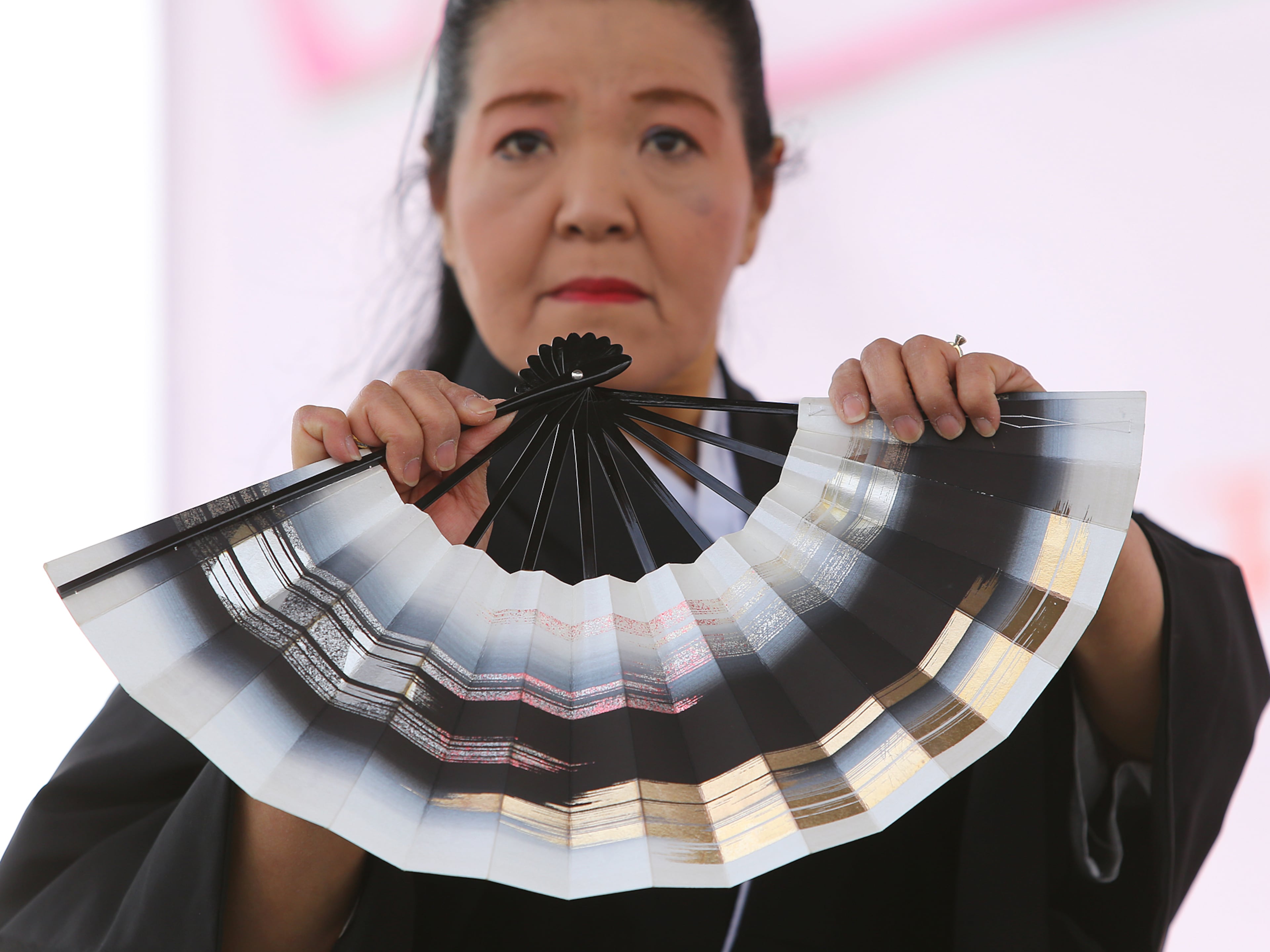 Kikue Chen leads the Kinuyo Shinobu Kai dance group in a traditional Japanese Cherry Blossum folk dance at the 33rd Annual Conyers Cherry Blossom Festival on Sunday, March 23, 2014, in Conyers.