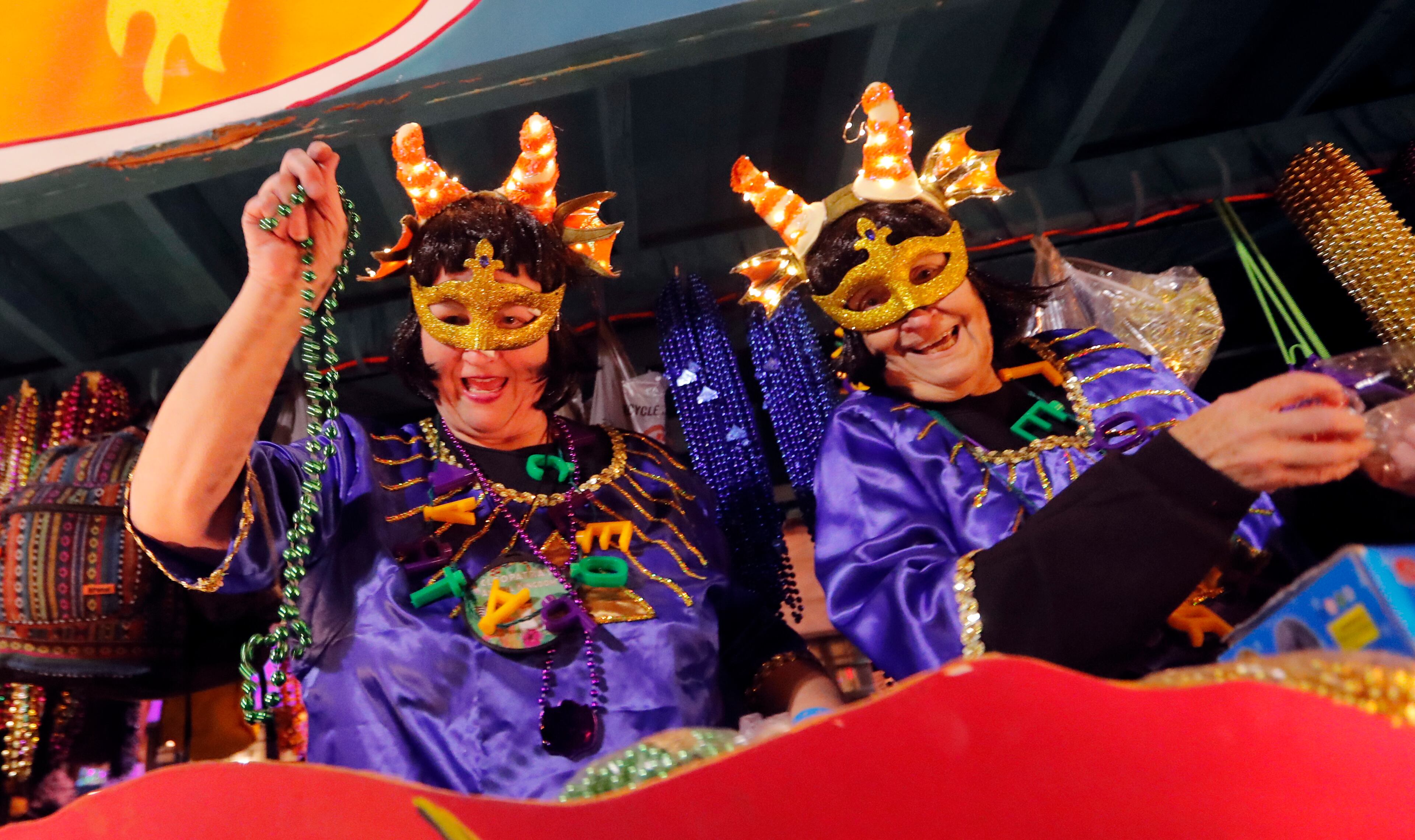 Float riders toss trinkets at the Krewe of Cleopatra Mardi Gras parade in New Orleans, Friday, Feb. 2, 2018. Mardi Gras season is kicking into high gear with a slew of major parades throughout New Orleans. Although Carnival season officially began Jan. 6, the festivities really kick into high gear the two weekends ahead of Fat Tuesday. This year Fat Tuesday is Feb. 13. (AP Photo/Gerald Herbert)