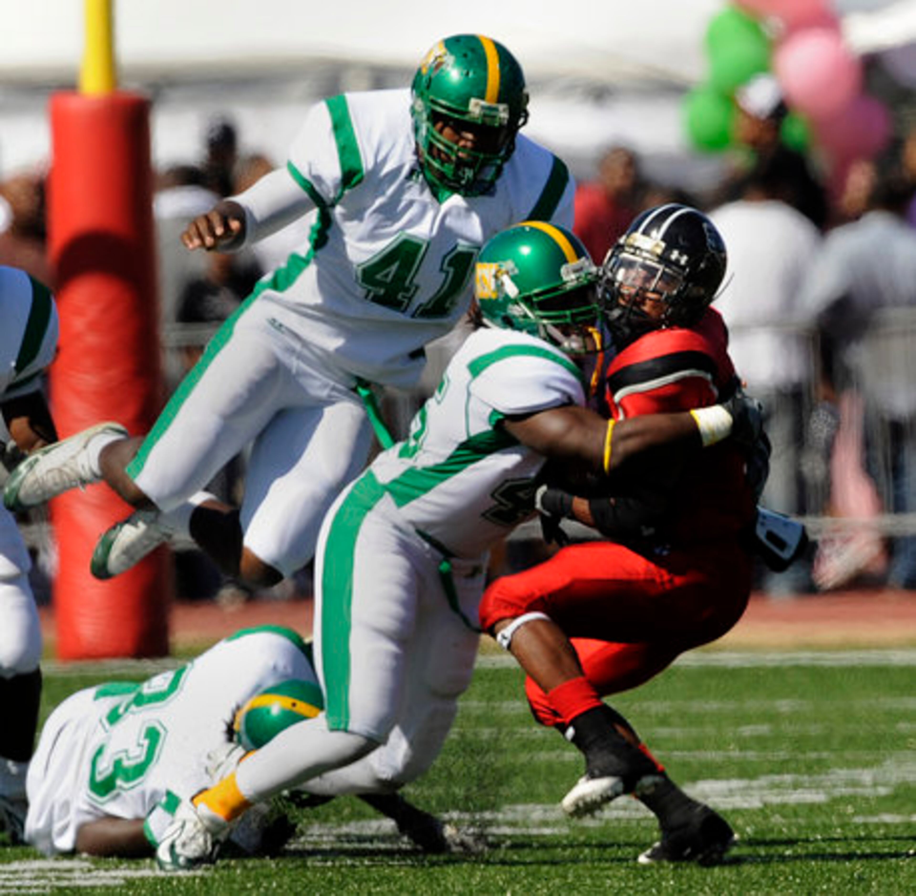 Thompson found the going tough at times against Kentucky State as he gets hit by Jemario Dorsey with Tyrell Henderson (41) flying in just in case.