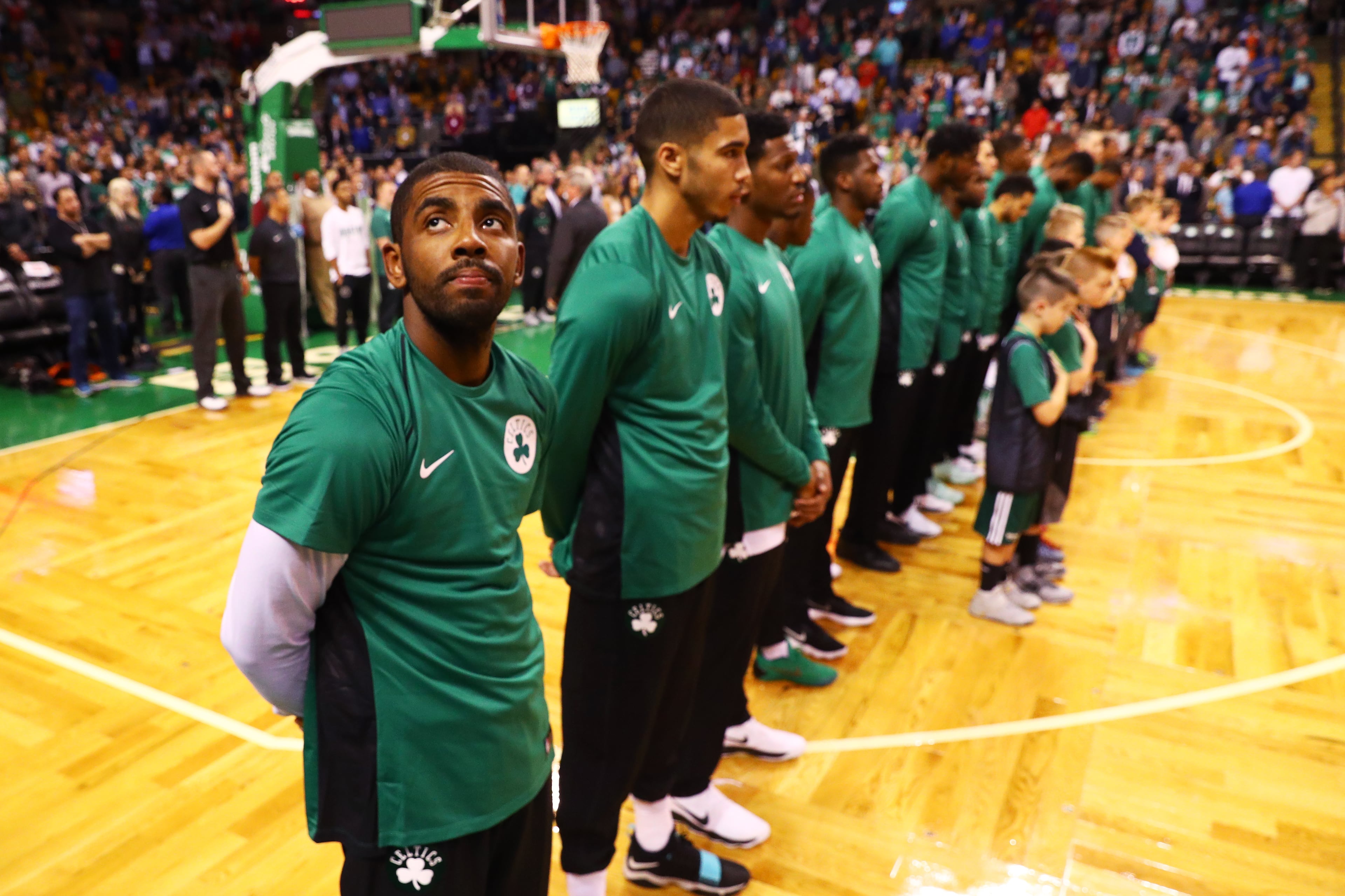 Kyrie Irving #11 of the Boston Celtics looks on during the national anthem before the game against the Charlotte Hornets at TD Garden on October 2, 2017.