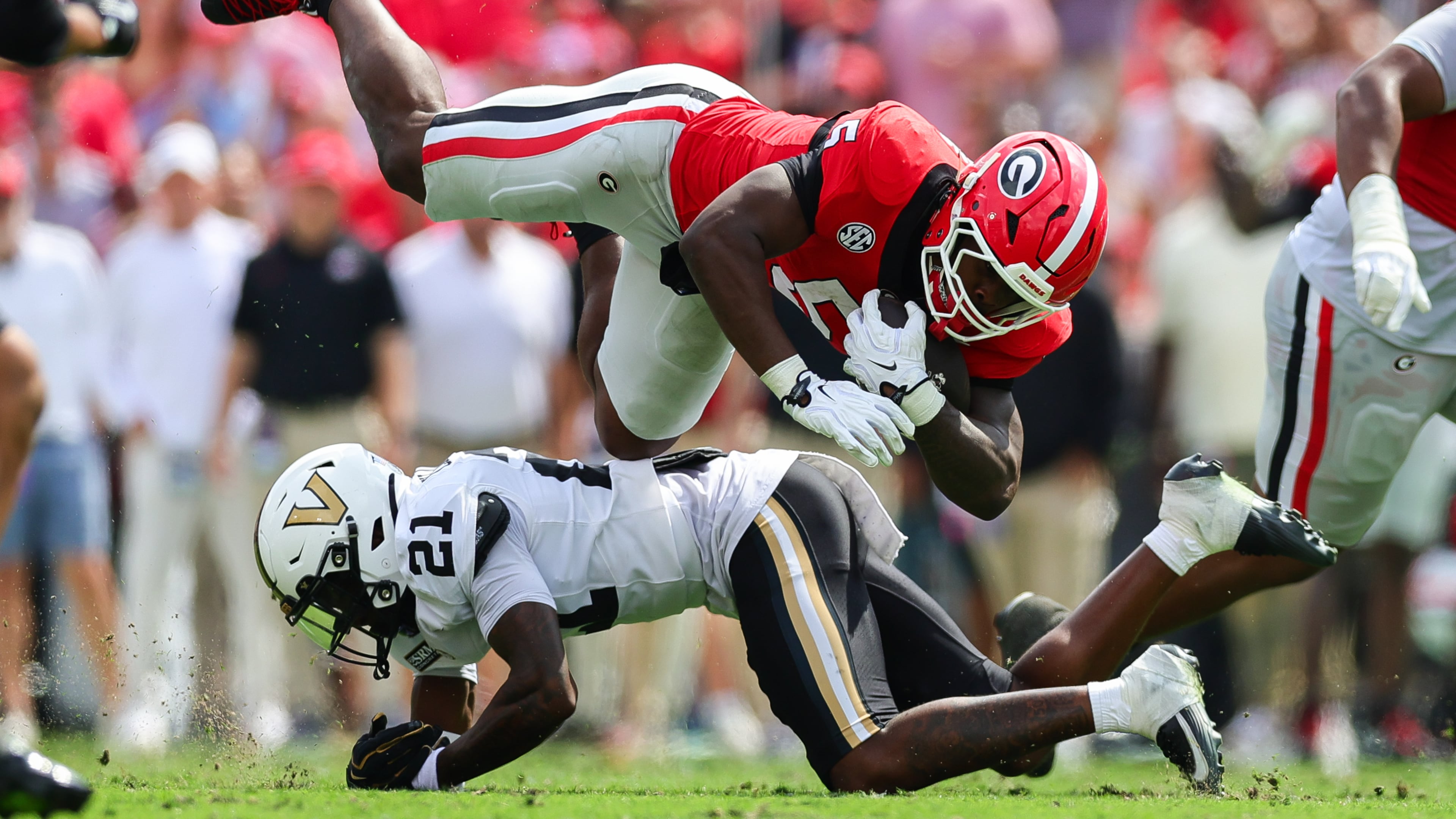 Vanderbilt safety Davin Chandler (21) tackles Georgia running back Chauncey Bowens (5) during the first half of an NCAA college football game, Saturday, Oct. 3, 2026, in Athens, Ga. (AP Photo/Colin Hubbard)