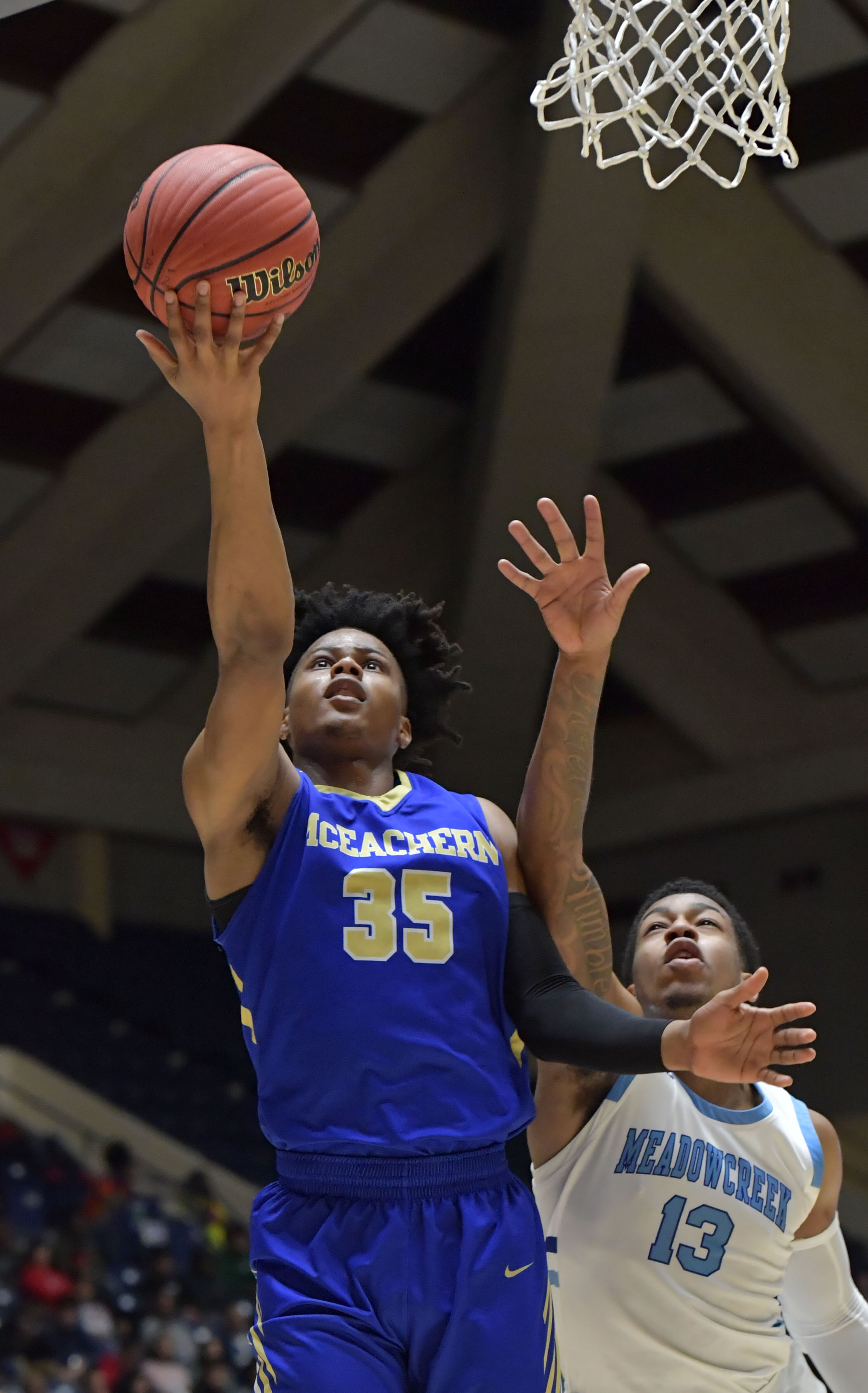 March 9, 2019 Macon - McEachern Isaac Okoro (35) goes to the basket past Meadowcreek Jammonie Watkins-Causey (13) in GHSA State Basketball Championship game at the Macon Centreplex in Macon on Saturday, March 9, 2019. McEachern won 62-54 over the Meadowcreek. HYOSUB SHIN / HSHIN@AJC.COM