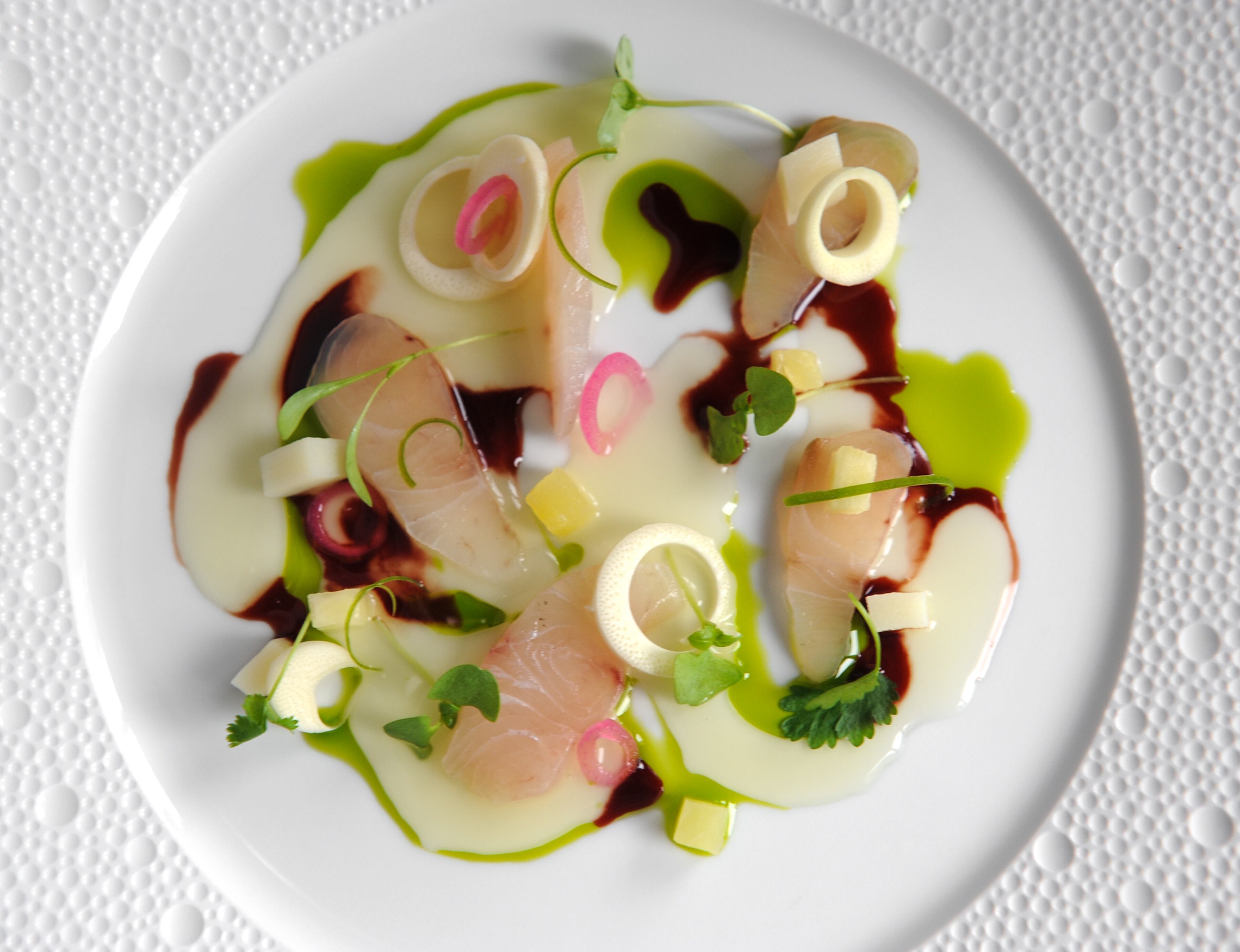 MARCH: John Kessler writes of Atlas in Buckhead, "Here is a restaurant that invites you to dine well but not worship your food, and to relish your two hours in this cosseting environment (tablecloths! noise control!) where you’ll be as comfortable in jeans as in business attire." Read the full review here. Pictured: Cured hiramasa kingfish in pineapple consommé, with chili, pomegranate and crisp ringlets of fresh heart of palm. (Becky Stein / beckysteinphotography.com)