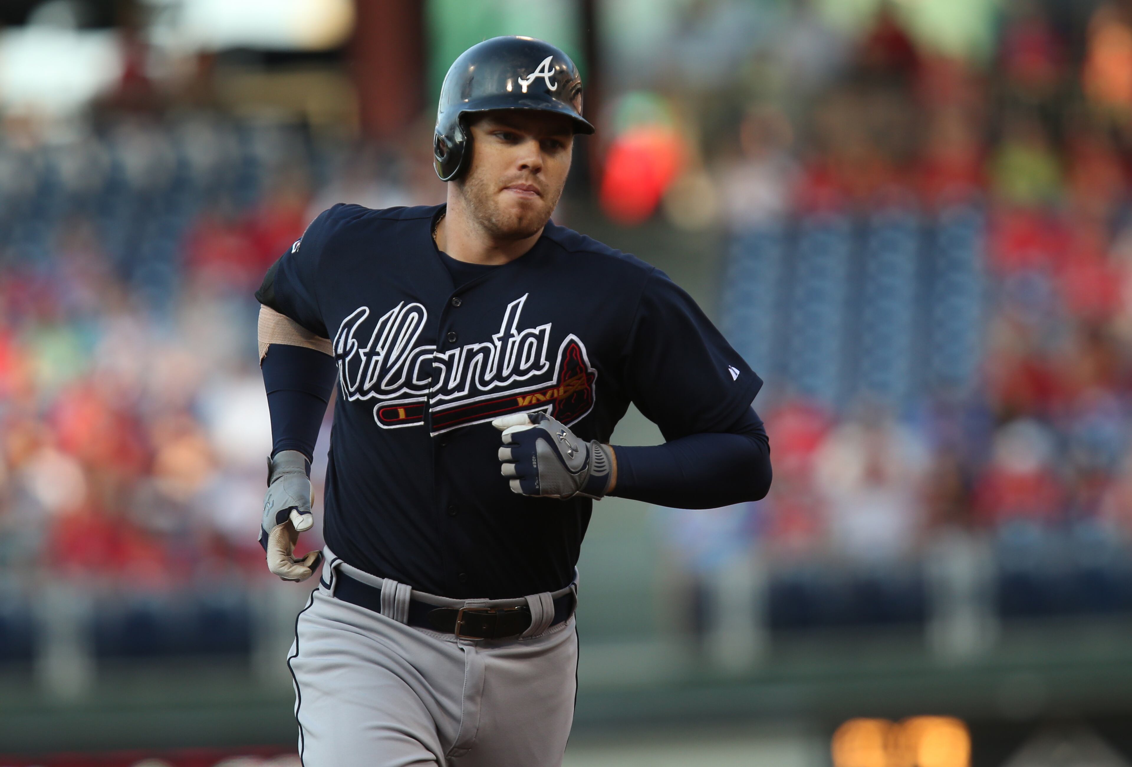 Atlanta Braves' Freddie Freeman rounds the bases after hitting a three-run home run in the first inning of a baseball game against the Philadelphia Phillies, Friday, June 27, 2014, in Philadelphia. (AP Photo/Laurence Kesterson)