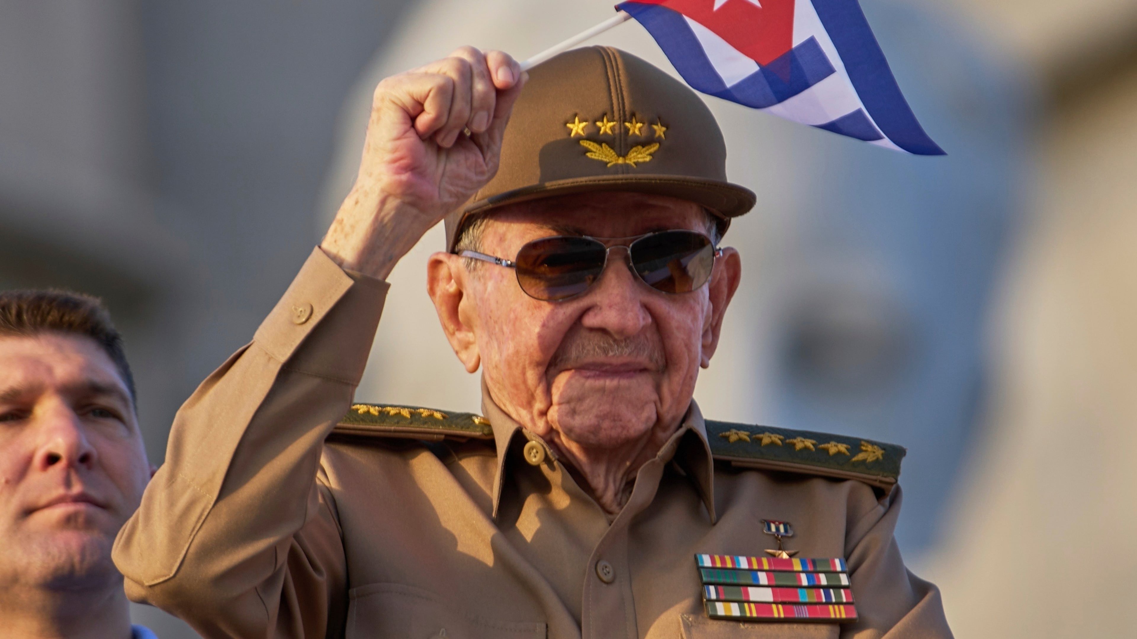 FILE - Raul Castro waves a Cuban national flag during a May Day parade at Revolution Square in Havana on May 1, 2025. (AP Photo/Ramon Espinosa, File)