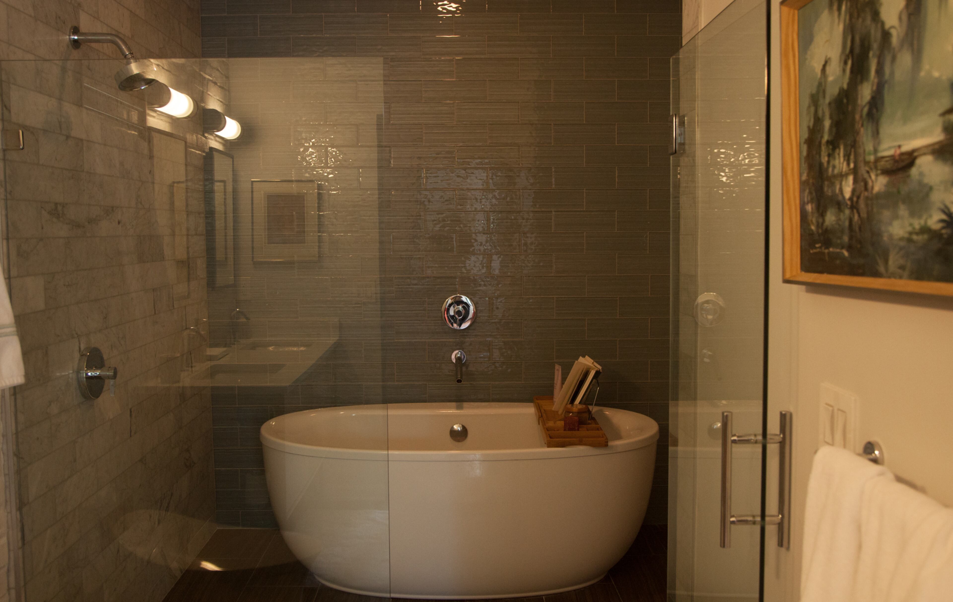 The renovated marble master bathroom has a walk-in shower with a soaking tub. The homeowners say the bathroom renovation, using items from the Kohler Signature Store in Buckhead, totaled about $35,000. They worked with designer Sandie Mazzi. Reann Huber/AJC FILE