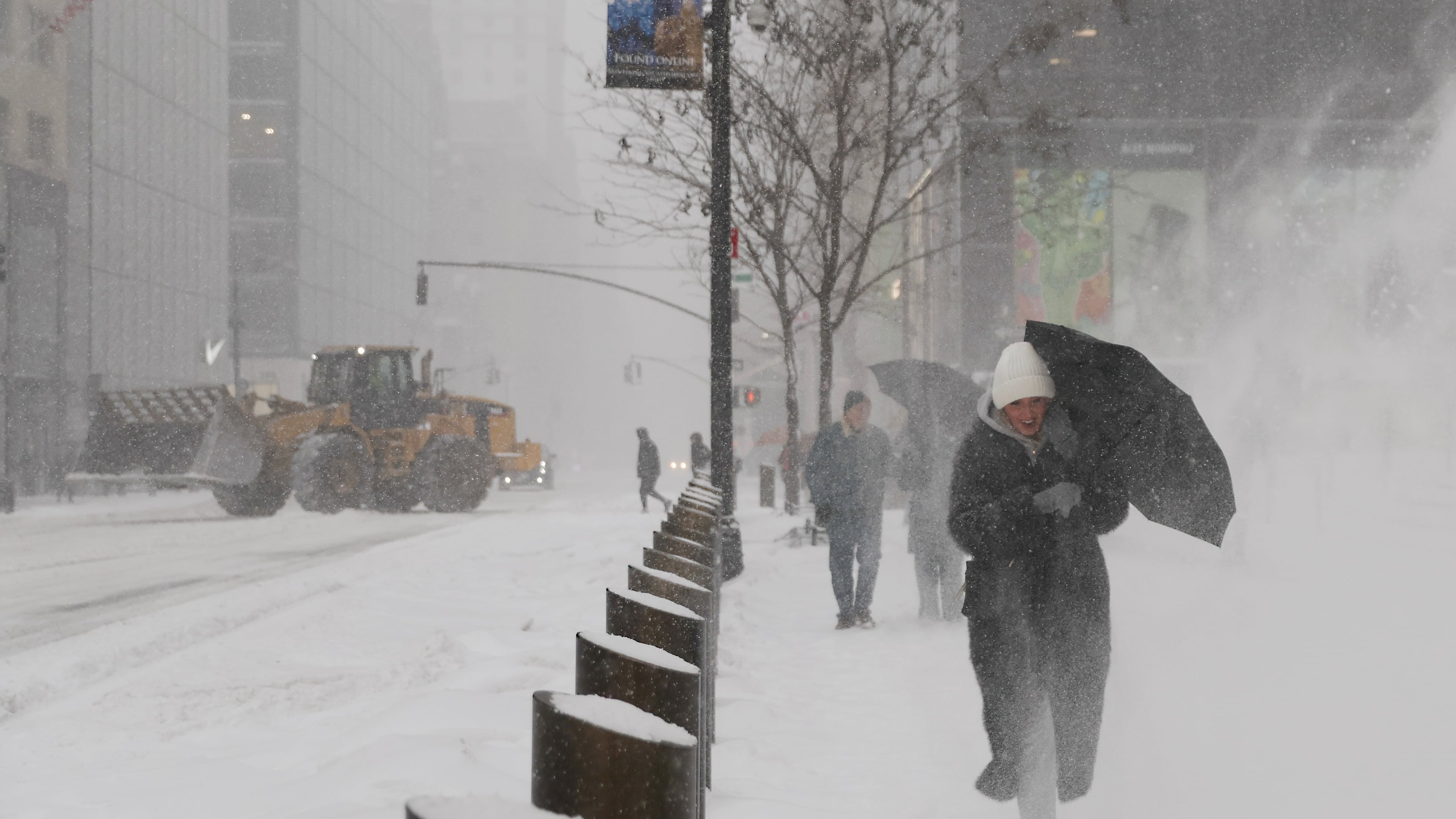 Pedestrians walk down Fifth Avenue during a winter storm, Sunday, Jan. 25, 2026, in New York. (AP Photo/Heather Khalifa)
