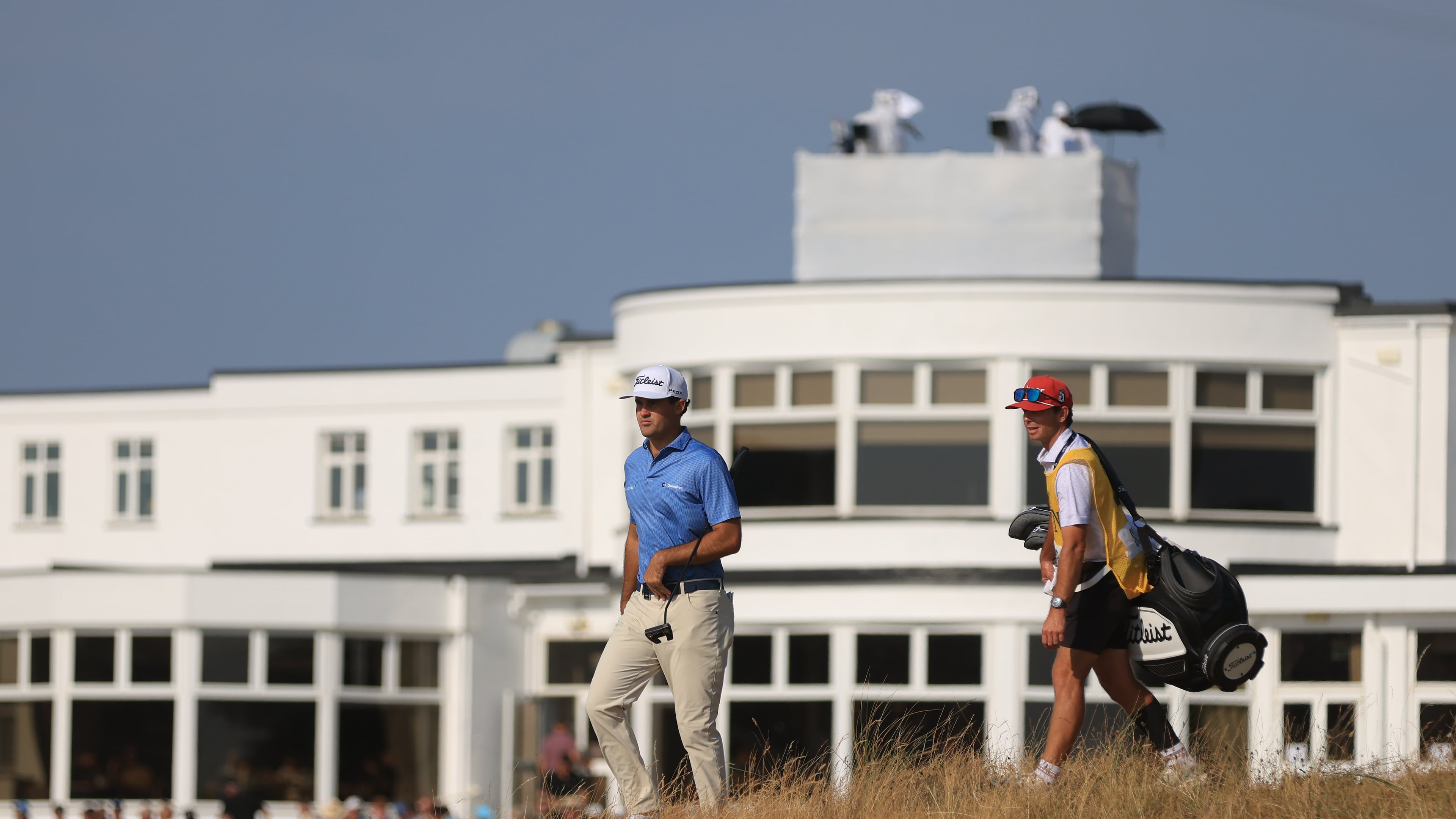 Jackson Suber of the United States, and his caddie Greyson Porter walks towards the 18th green during the first day of the British Open Golf championships at Royal Birkdale golf club, in Southport, England, Thursday, July 16, 2026. (AP Photo/Peter Morrison)