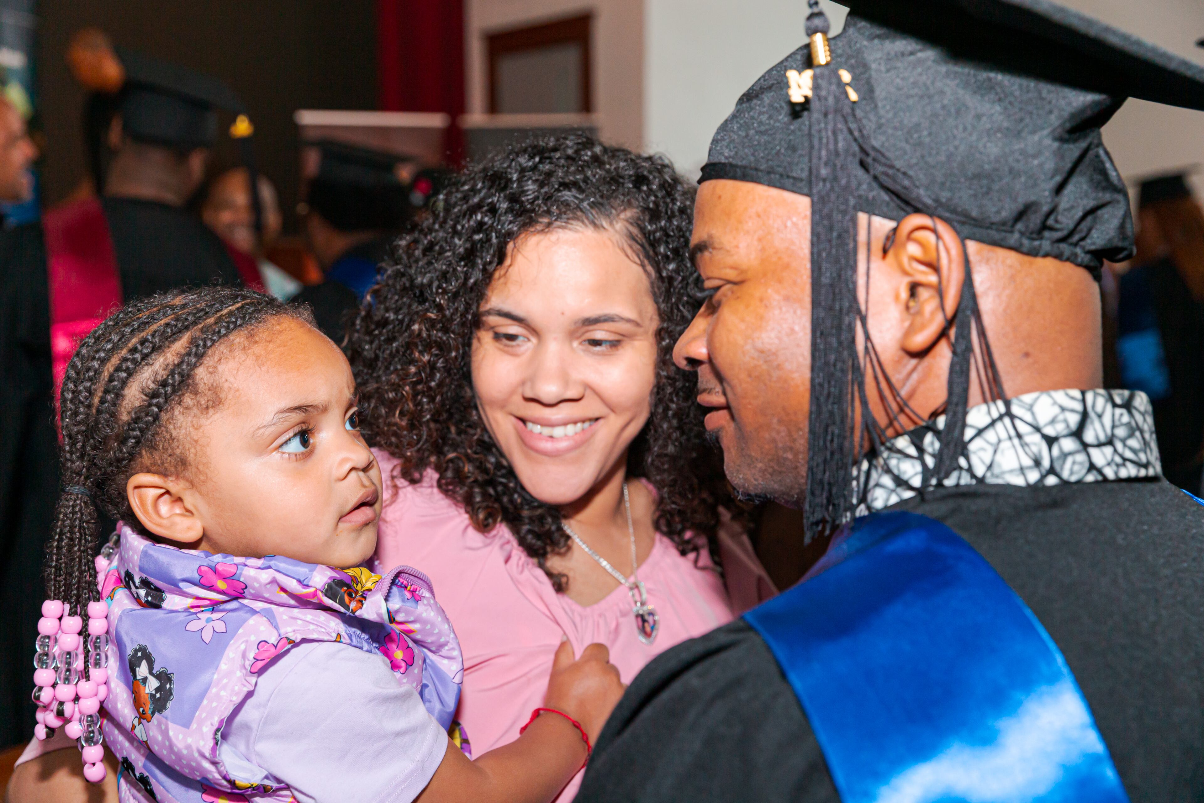 A Fathers Incorporated graduate hugs his family. (Courtesy of Fathers Incorporated)