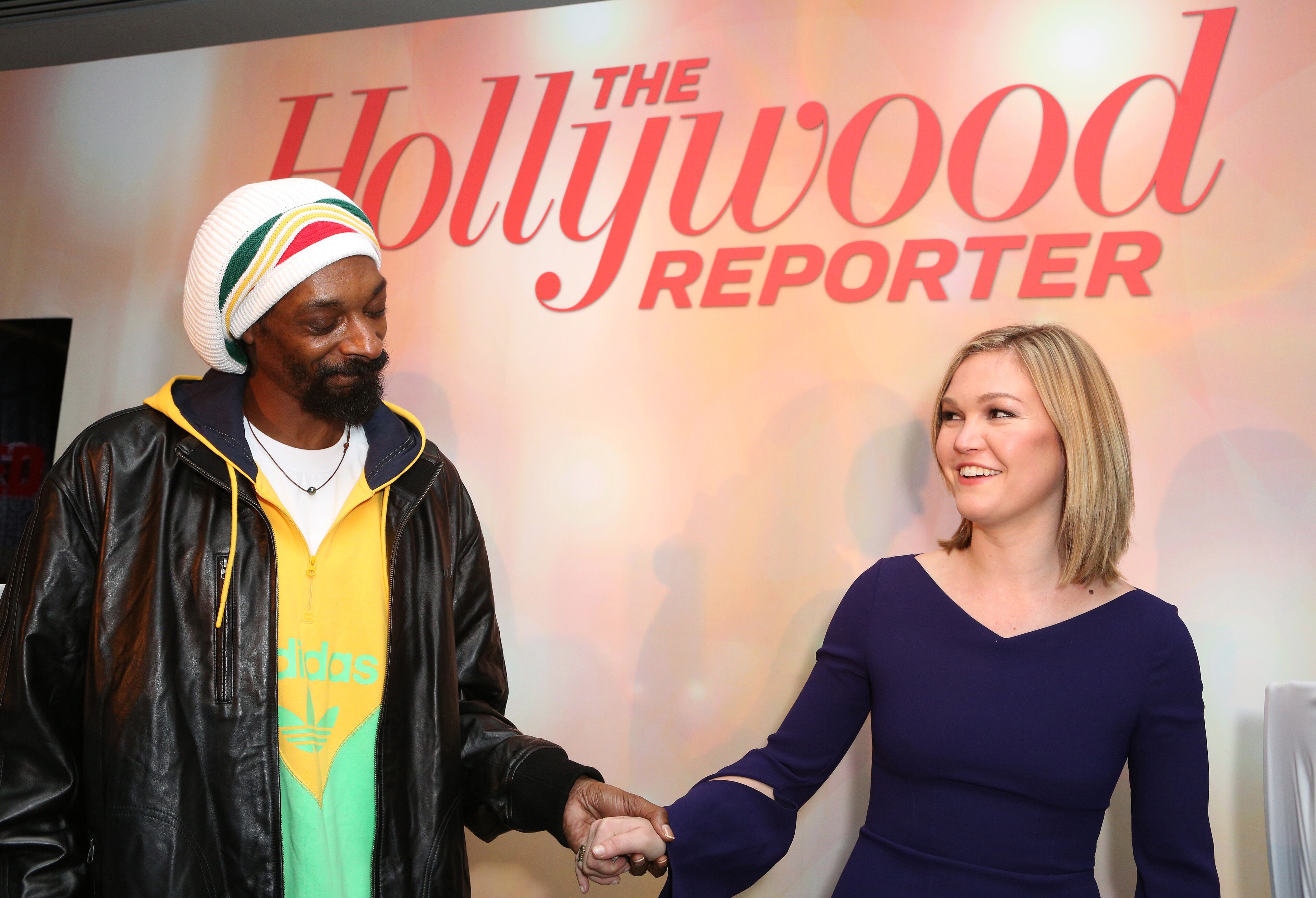 Snoop Dogg, AKA Snoop Lion, left, and Julia Stiles perform at The Hollywood Reporter Nominees' Night Insider at Spago on Monday, Feb. 4, 2013, in Beverly Hills, Calif.