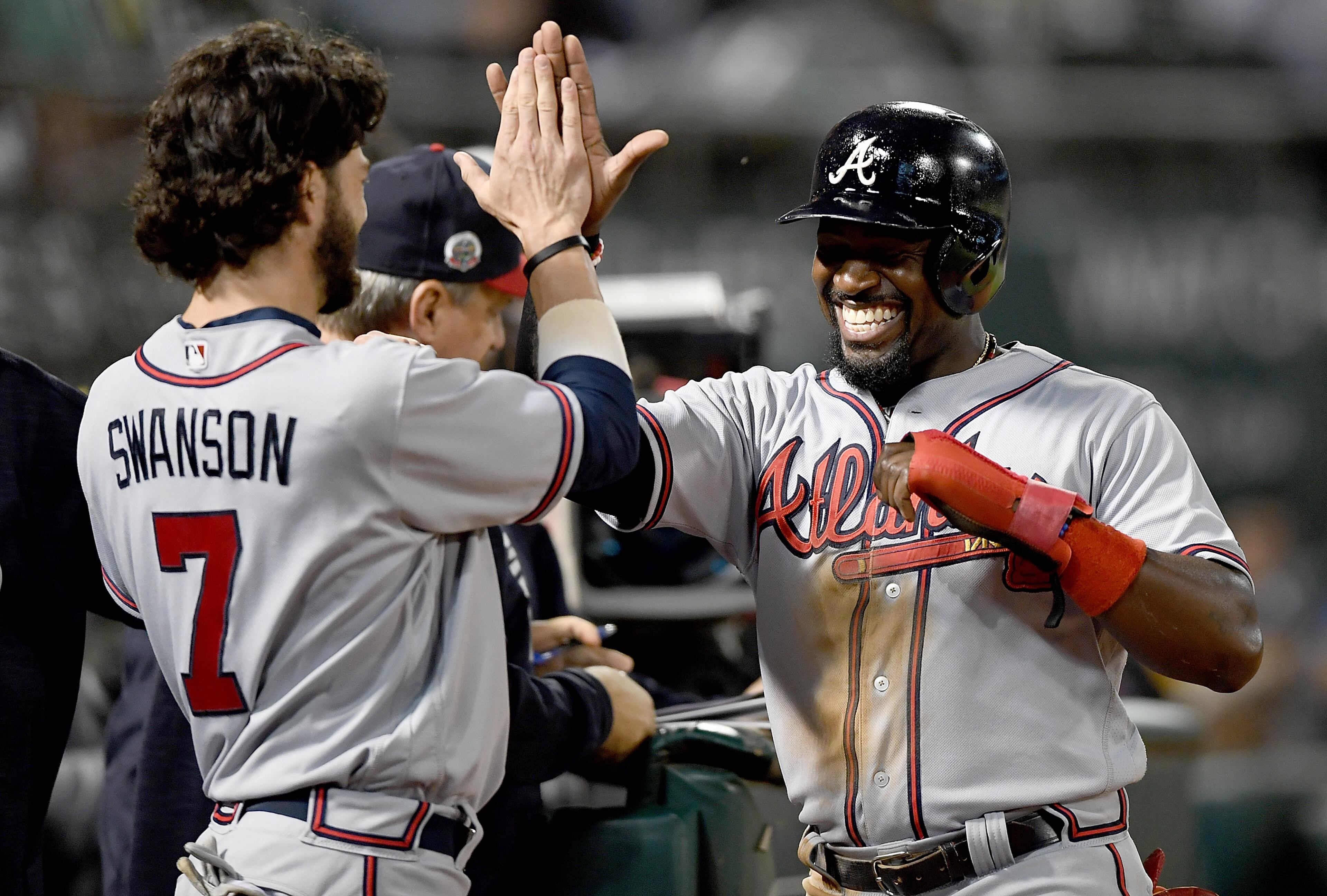 OAKLAND, CA - JUNE 30: Brandon Phillips #4 of the Atlanta Braves is congratulated by Dansby Swanson #7 after Phillips scored against the Oakland Athletics in the top of the ninth inning at Oakland Alameda Coliseum on June 30, 2017 in Oakland, California. (Photo by Thearon W. Henderson/Getty Images)