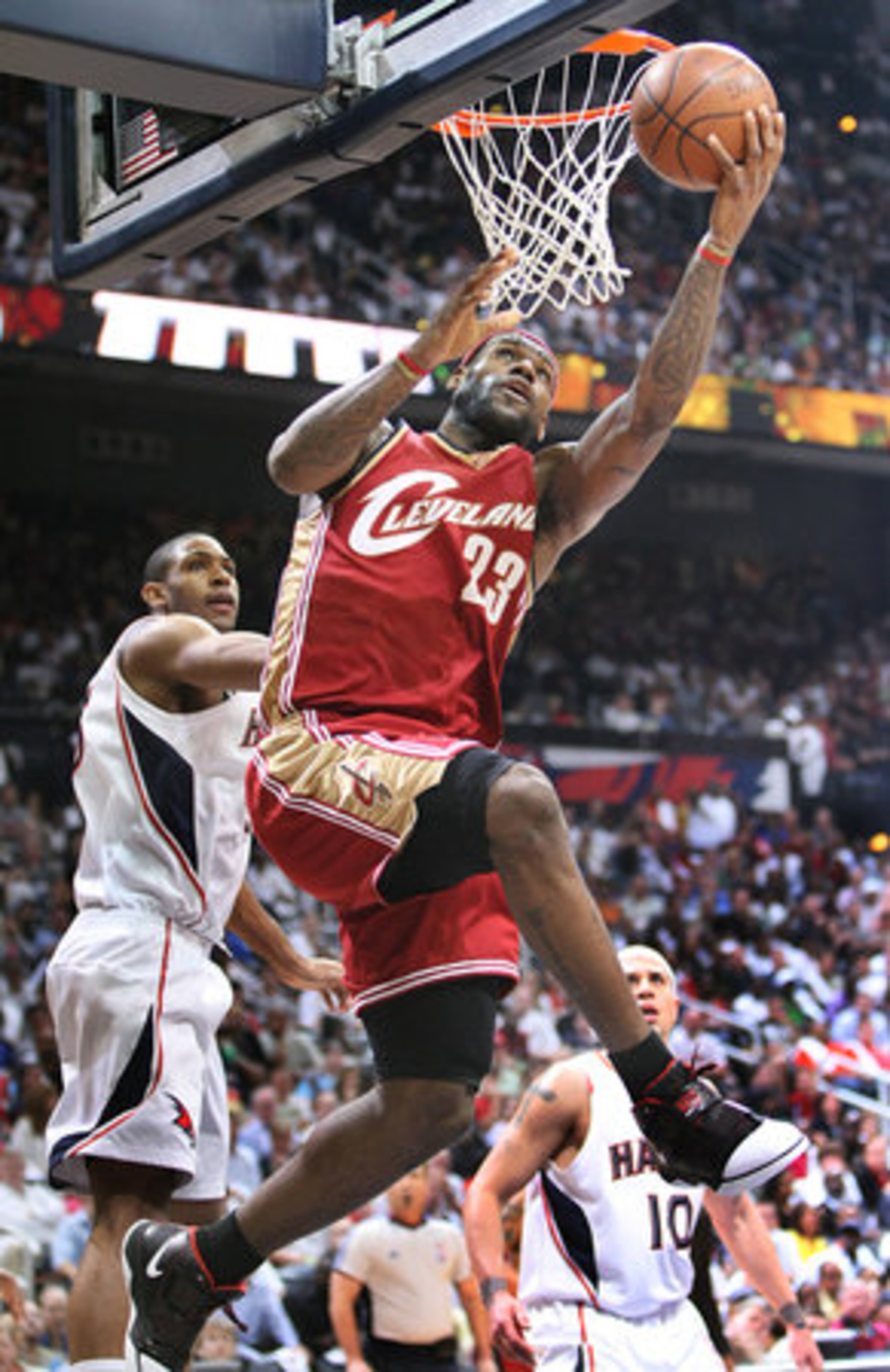 Cavaliers forward Lebron James gets past Hawks center Al Horford for 2 points from under the basket.
