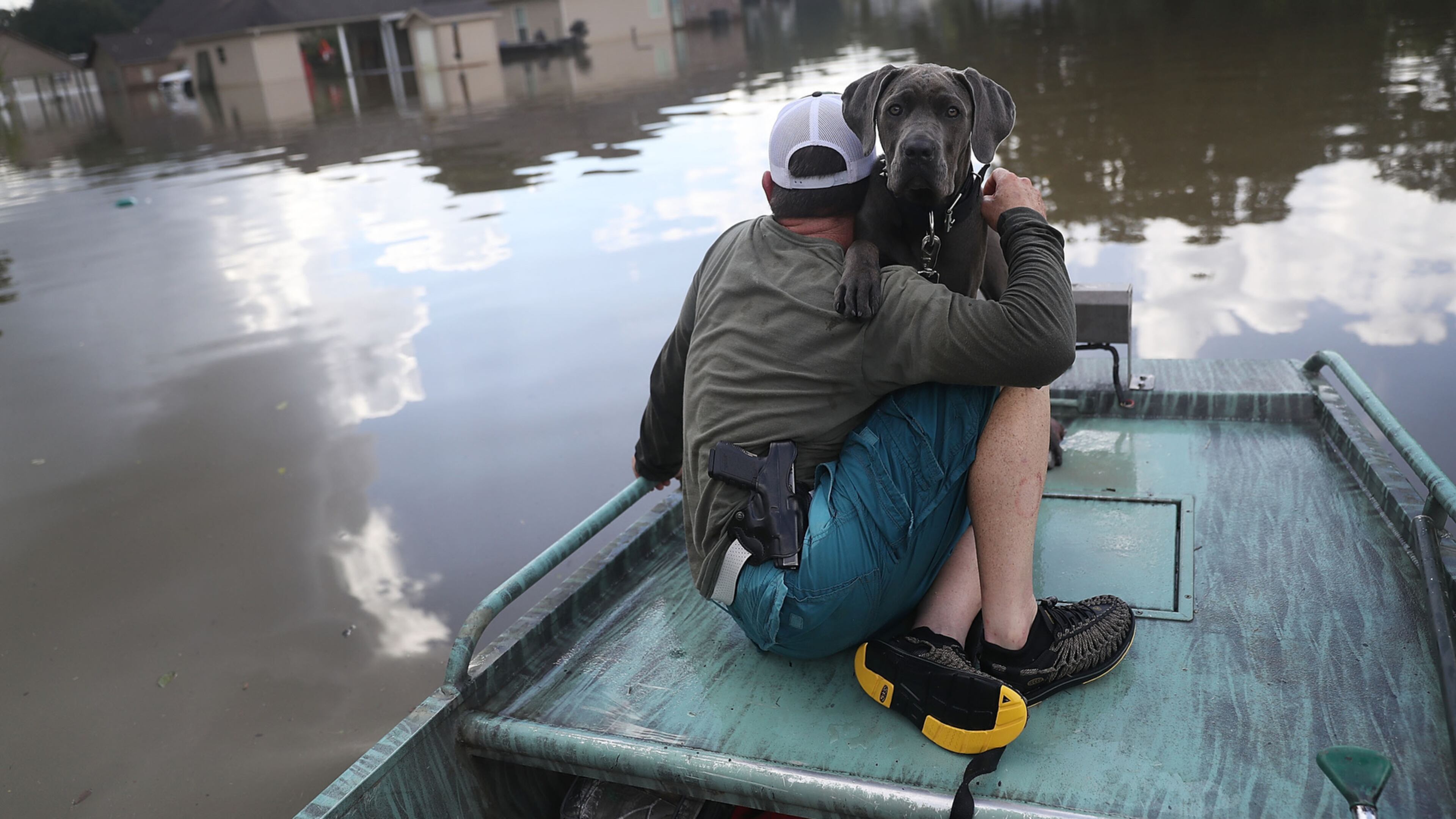 SORRENTO, LA - AUGUST 17: Travis Guedry and his dog Ziggy glide through floodwaters keeping an eye out for people in need on August 17, 2016 in Sorrento, Louisiana. Tremendous downpours have resulted in disastrous flooding, responsible for at least seven deaths and thousands of homes being damaged. (Photo by Joe Raedle/Getty Images)