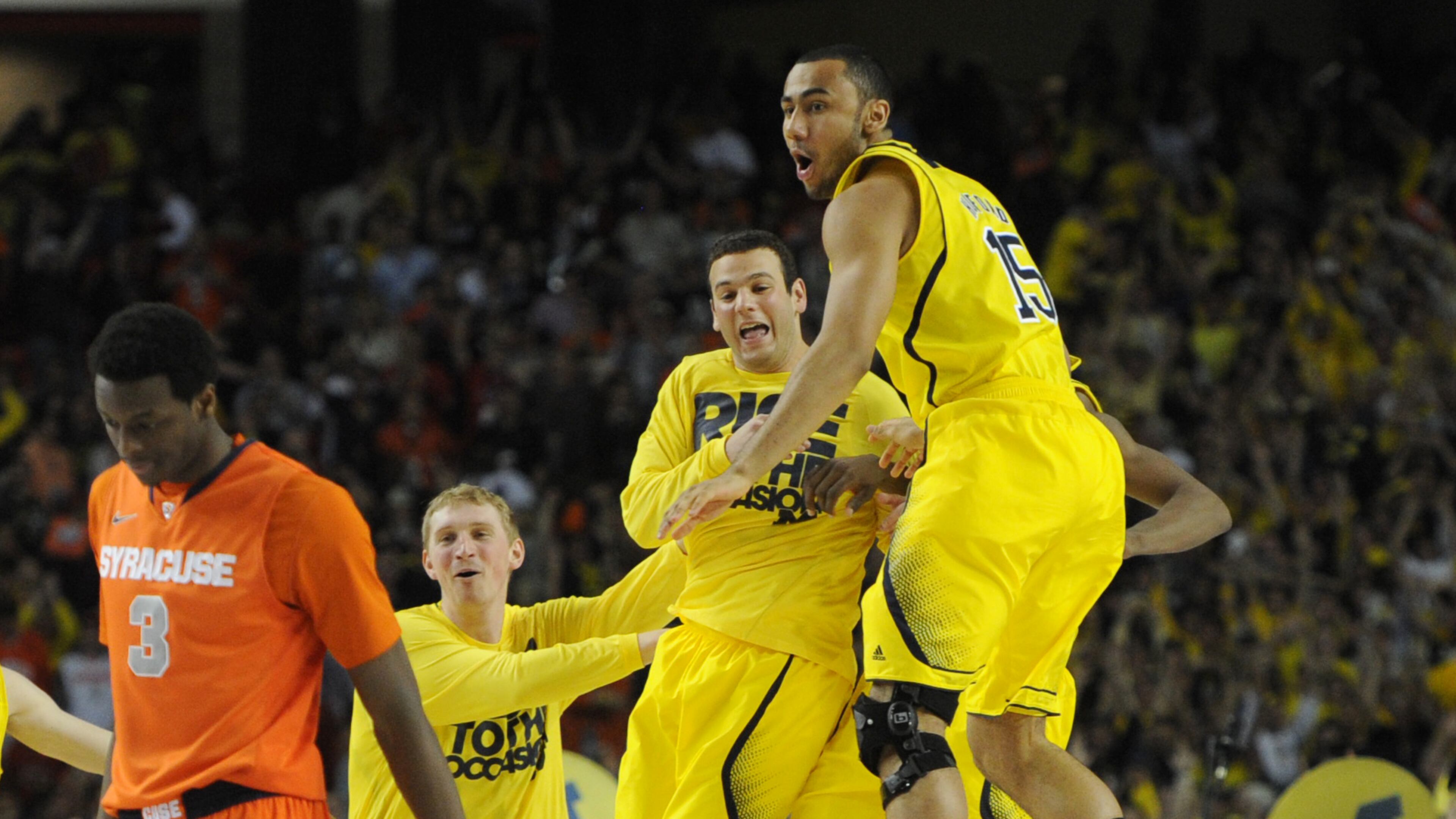 April 6, 2013 Atlanta: Michigan players celebrate after defeating Syracuse inside the Georgia Dome on Saturday, April 6, 2013. Michigan will play Louisville for National Championship on Monday. JOHNNY CRAWFORD / JCRAWFORD@AJC.COM