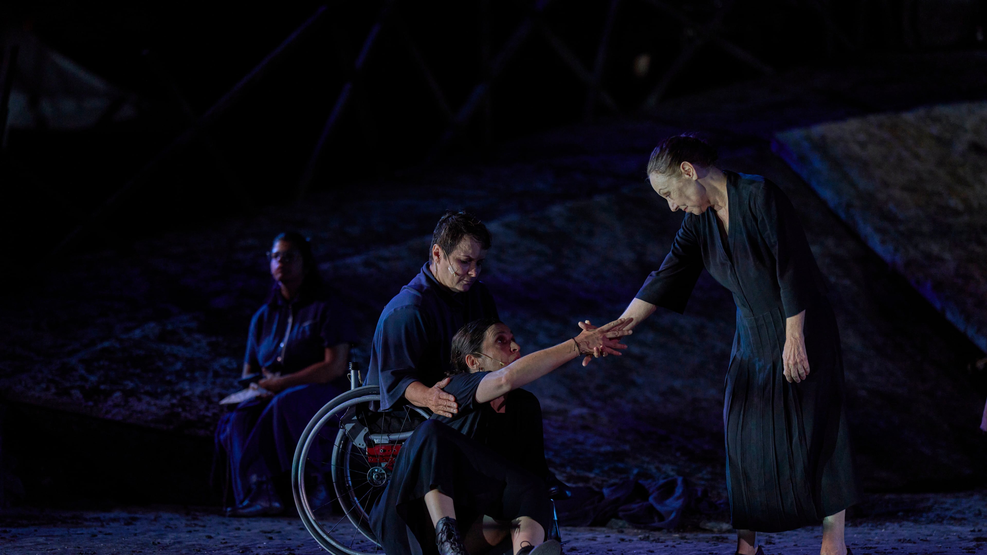 From left to right, Eirini Kourouvani, a wheelchair dancer, Evi Saoulidou and Lydia Fotopoulou perform during a dress rehearsal of Euripides' tragedy The Trojan Women, staged by the National Theatre of Greece, at the Ancient Theater of Epidaurus, Greece, on Thursday, July 30, 2026. (AP Photo/Petros Giannakouris)