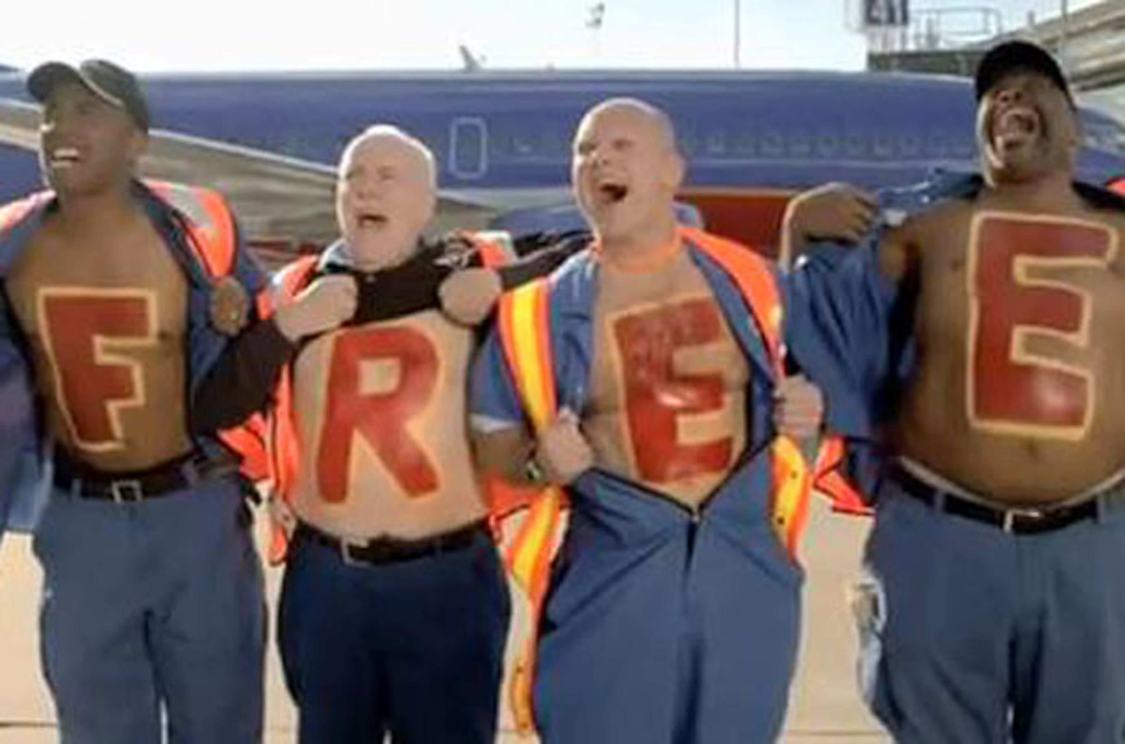Southwest's "Battle Cry" commercial features ramp workers running towards an AirTran plane with its name and tail logo pixellated in a half-hearted disguise.