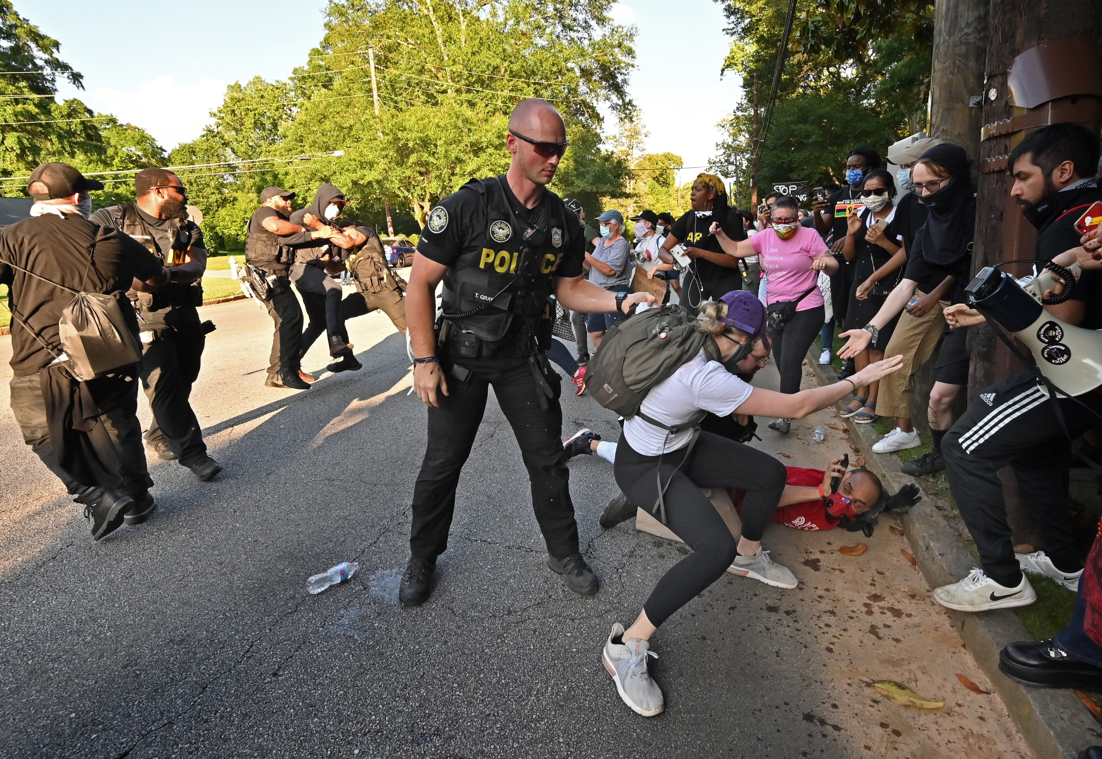 May 30, 2020 Atlanta - Police arrested protesters as they rally across the street from the Governor's Mansion in Buckhead on Saturday, May 30, 2020. A second day of protests Saturday began with a crowd outside the Governorâs Mansion and grew to include demonstrations in downtown Atlanta. Mayor Keisha Lance Bottoms implemented a curfew for the city following a night of chaotic protests Friday that led to vandalism and looting in parts of downtown Atlanta and Buckhead. (Hyosub Shin / Hyosub.Shin@ajc.com)
