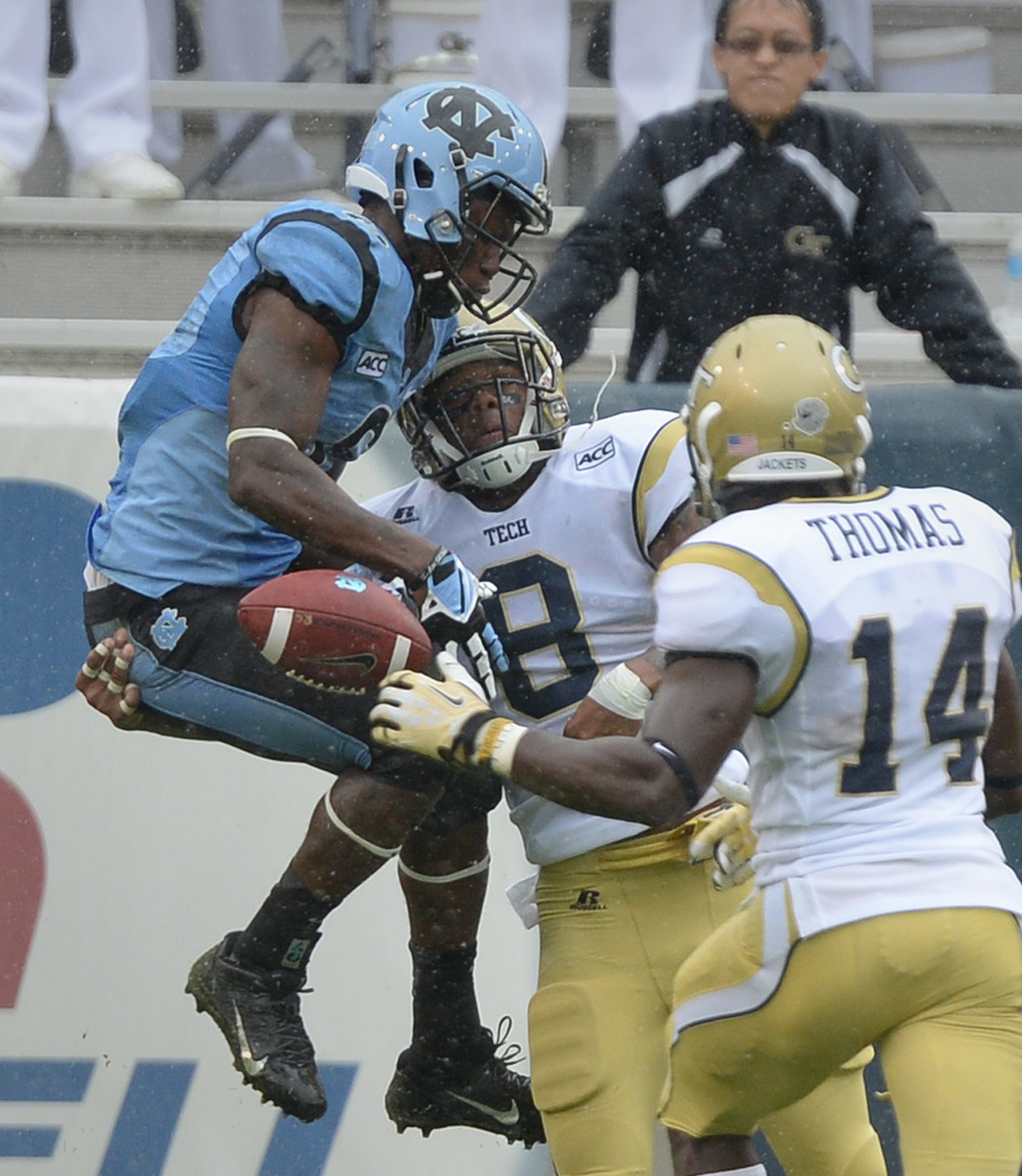 North Carolina's Sean Tapley (6) drops the ball after taking a hard hit from Georgia Tech's Louis Young. (8) in the second quarter.