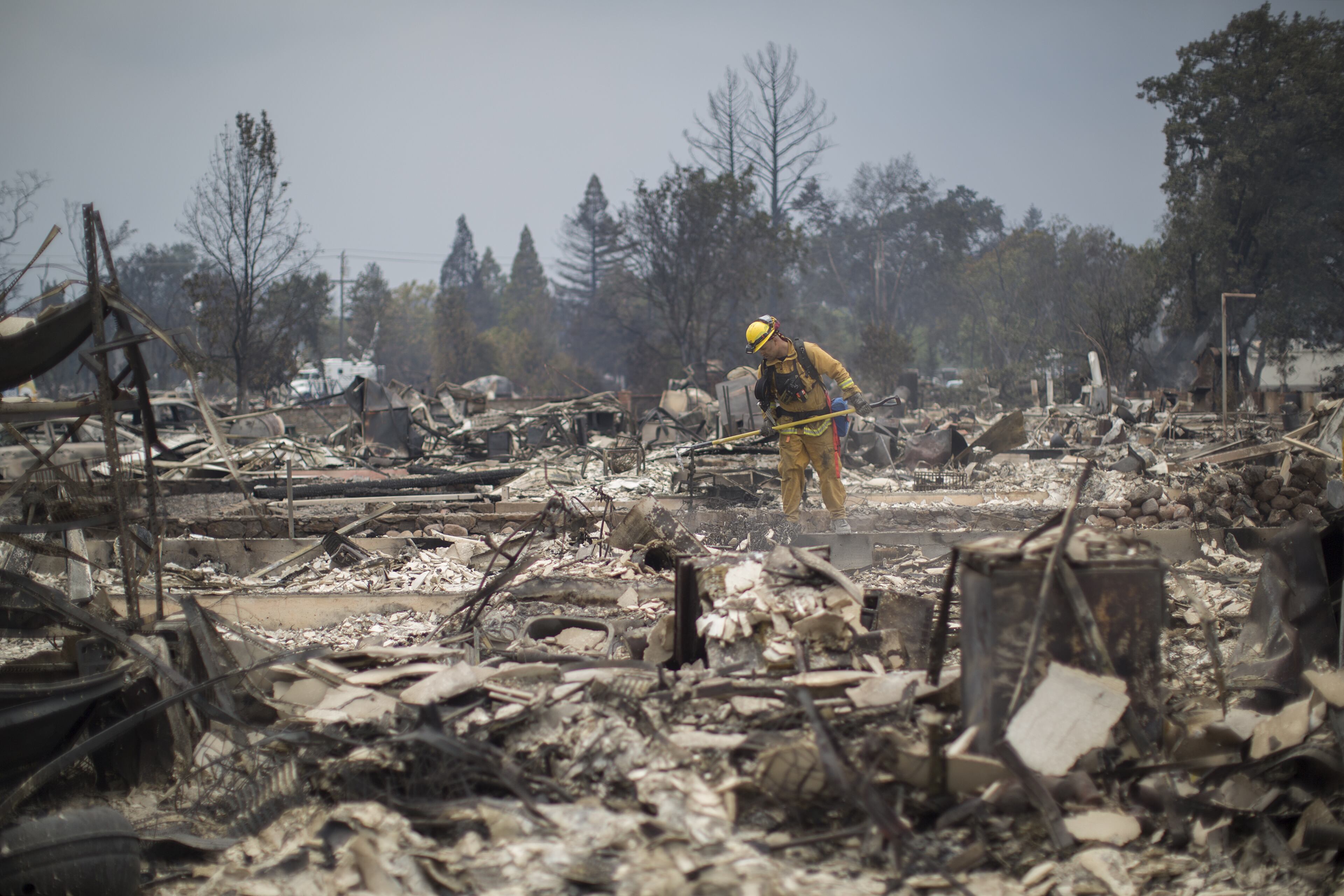 Firefighters look through the ruins of structures burned by the Valley Fire on September 14, 2015 in Middletown, California. The 95-square-mile fire has destroyed hundreds of homes and is only five percent contained. (Photo by David McNew/Getty Images)