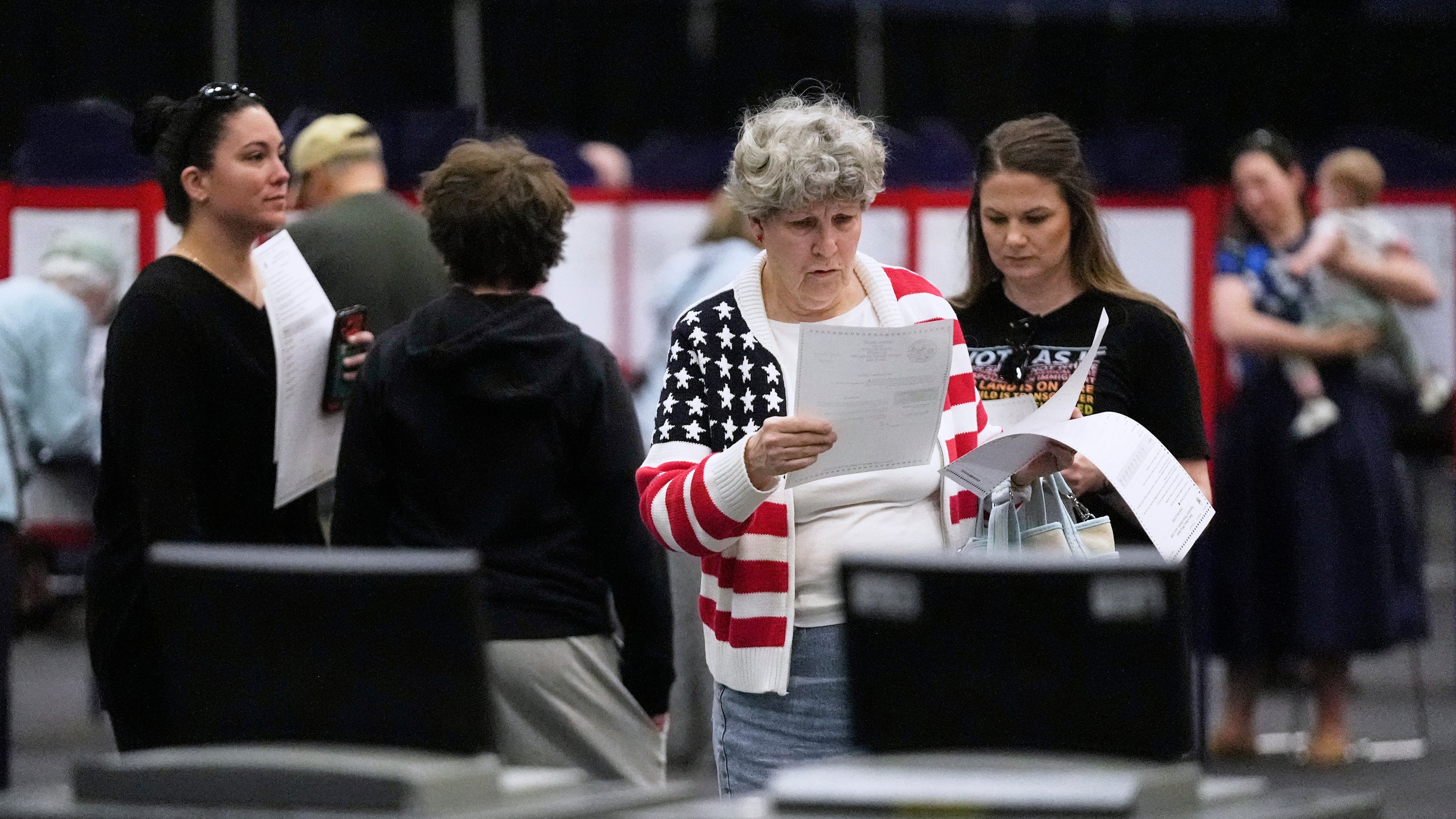 Mary Saunders looks over her choices one last time before casting her ballots in the Maine Primary, Tuesday, June 9, 2026, in Augusta, Maine. (AP Photo/Robert F. Bukaty)