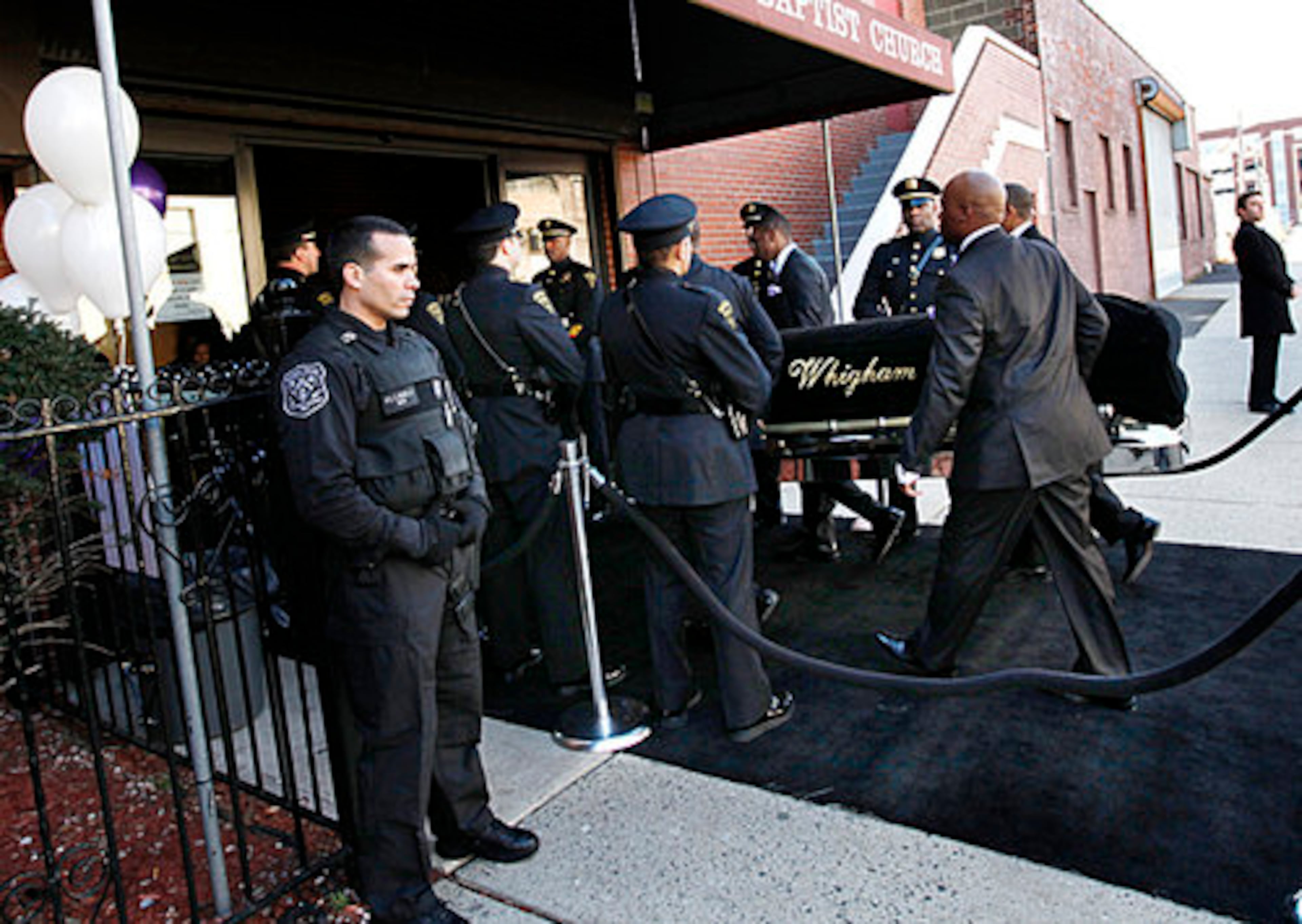 A coffin holding the remains of singer Whitney Houston is carried into the New Hope Baptist Church before funeral services for the singer in Newark, N.J., Saturday, Feb. 18, 2012.