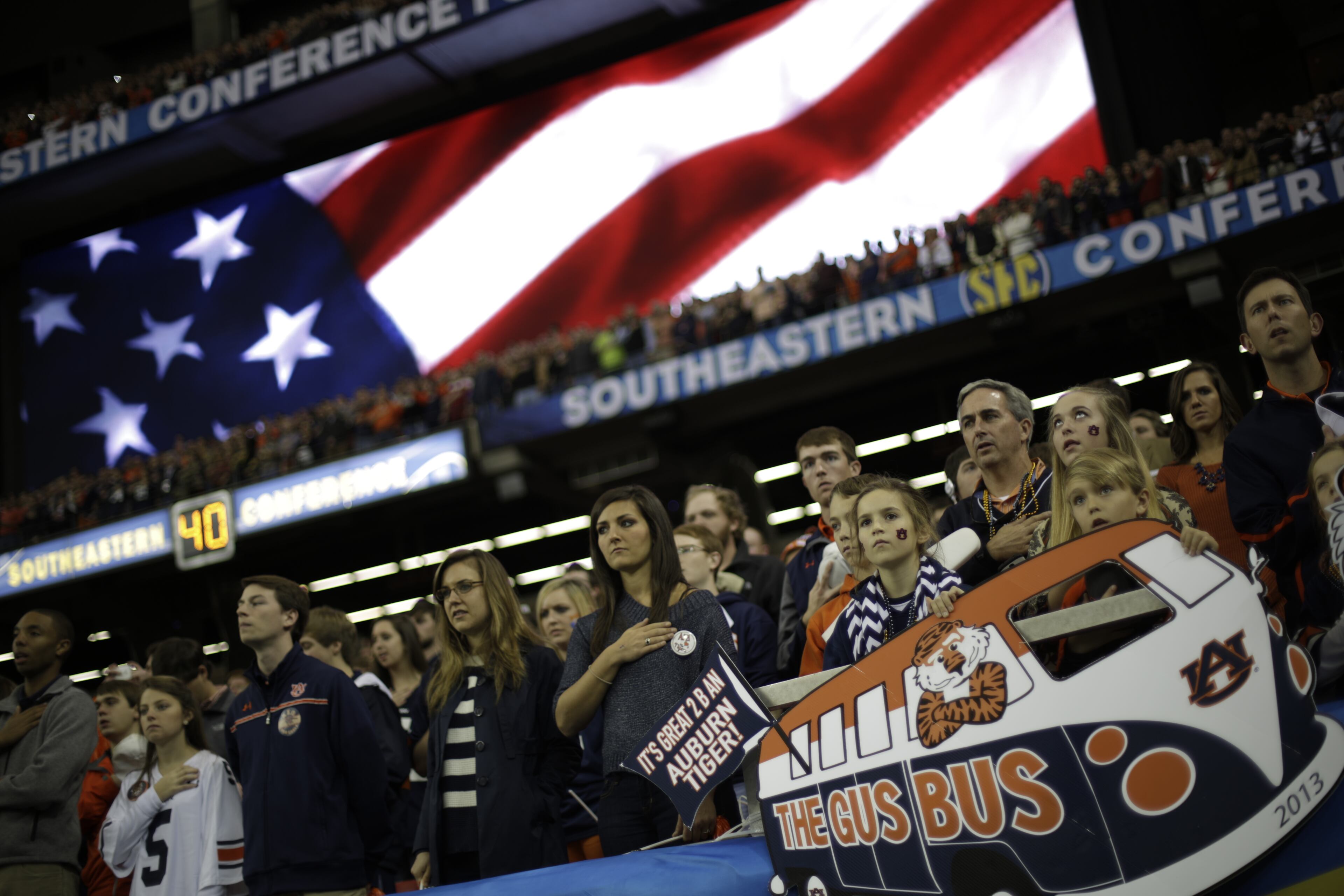 Fans watch the bands play during the National anthem before the first half of the Southeastern Conference NCAA football championship game between the Auburn and the Missouri, Saturday, Dec. 7, 2013, in Atlanta. (AP Photo/David Goldman)