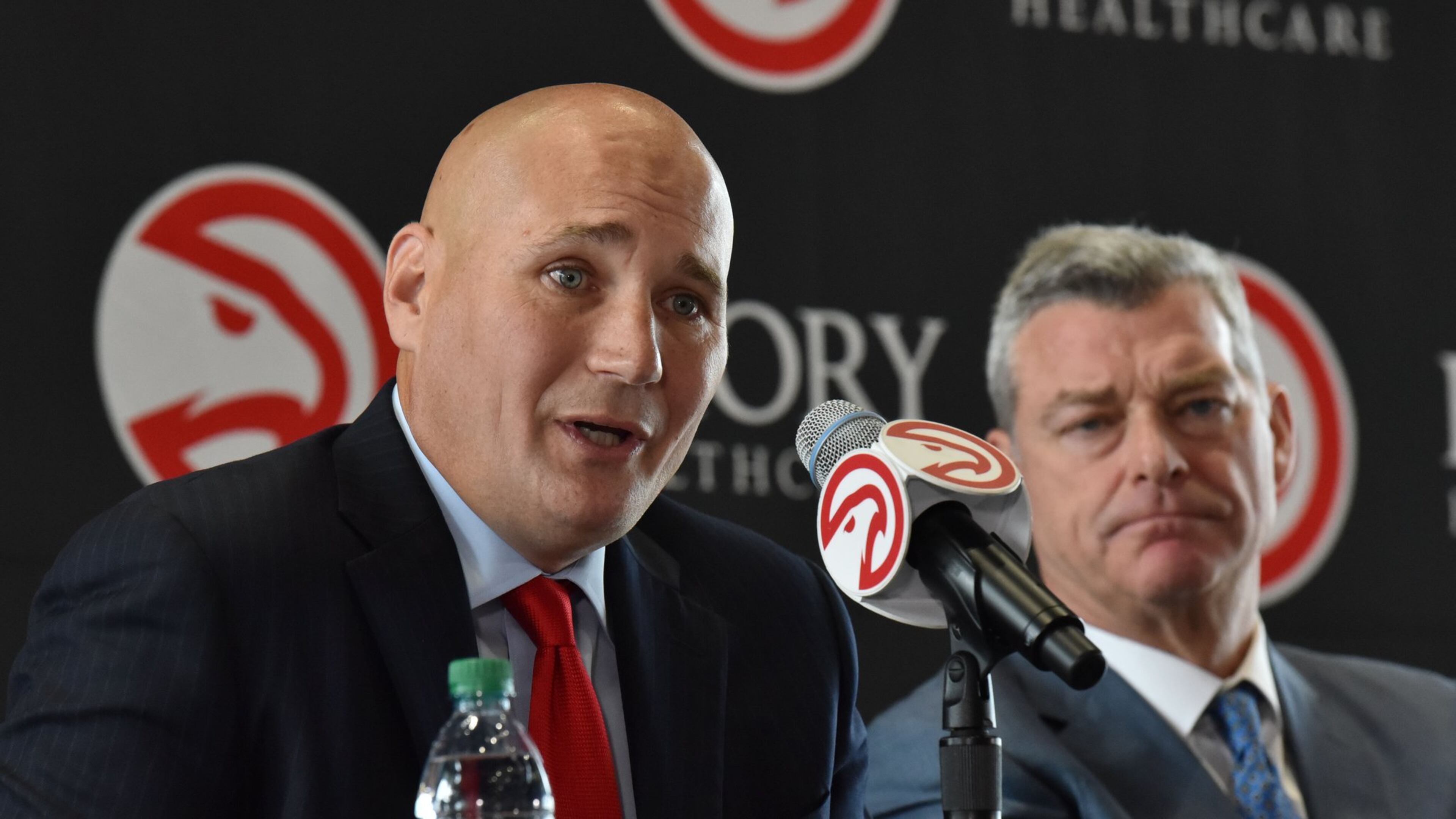 New Hawks GM Travis Schlenk speaks as Hawks principal owner Tony Ressler looks on during an introductory news conference at Philips Arena on Friday, June 2, 2017. HYOSUB SHIN / HSHIN@AJC.COM