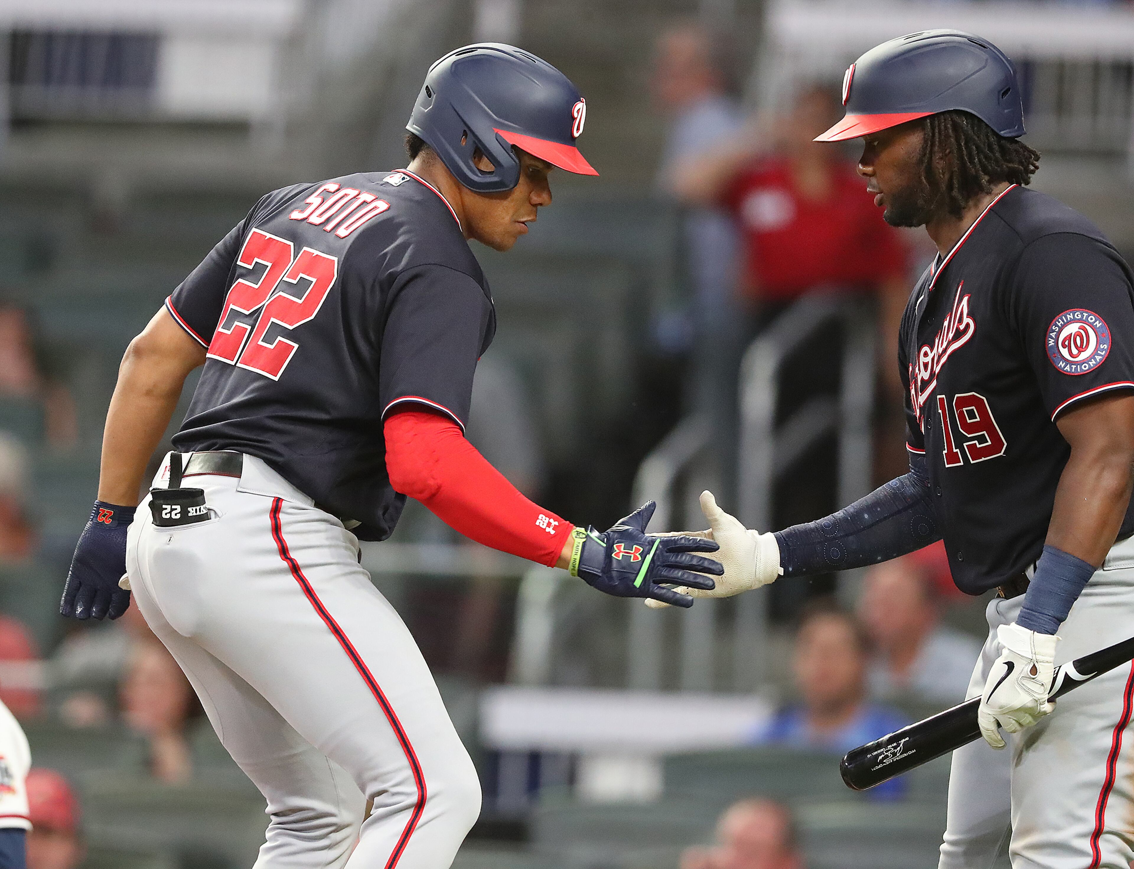 Washington Nationals outfielder Juan Soto (left) gets five from Josh Bell hitting a solo homer to take a 3-2 lead over the Atlanta Braves during the seventh inning. “Curtis Compton / Curtis.Compton@ajc.com”