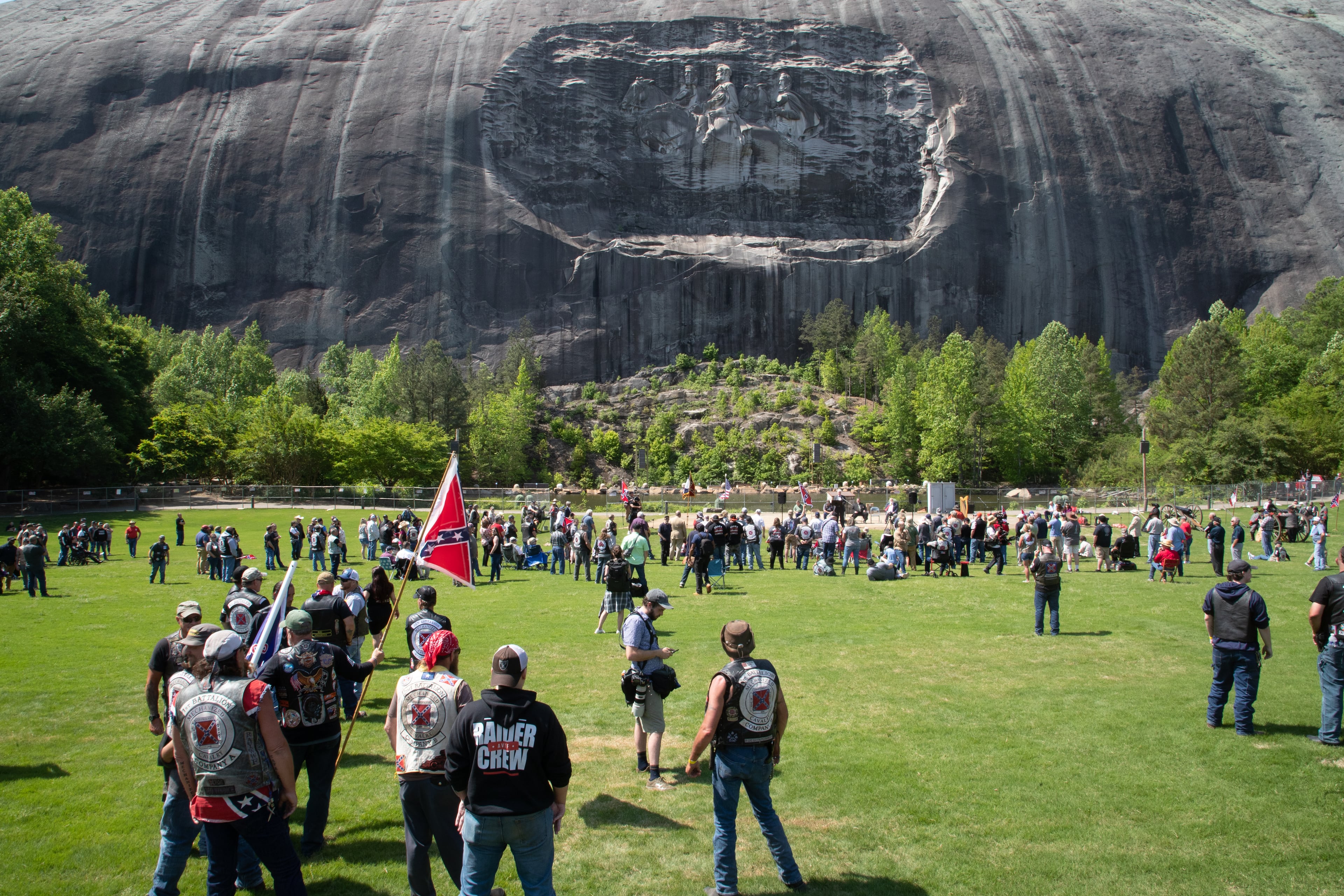 People gather on the lawn in front of the 90-foot tall carving of Stonewall Jackson, Robert E. Lee and Jefferson Davis at Stone Mountain State Park during the Sons of Confederate Veterans rally Saturday, April 30, 2022. (Photo: Steve Schaefer / steve.schaefer@ajc.com)