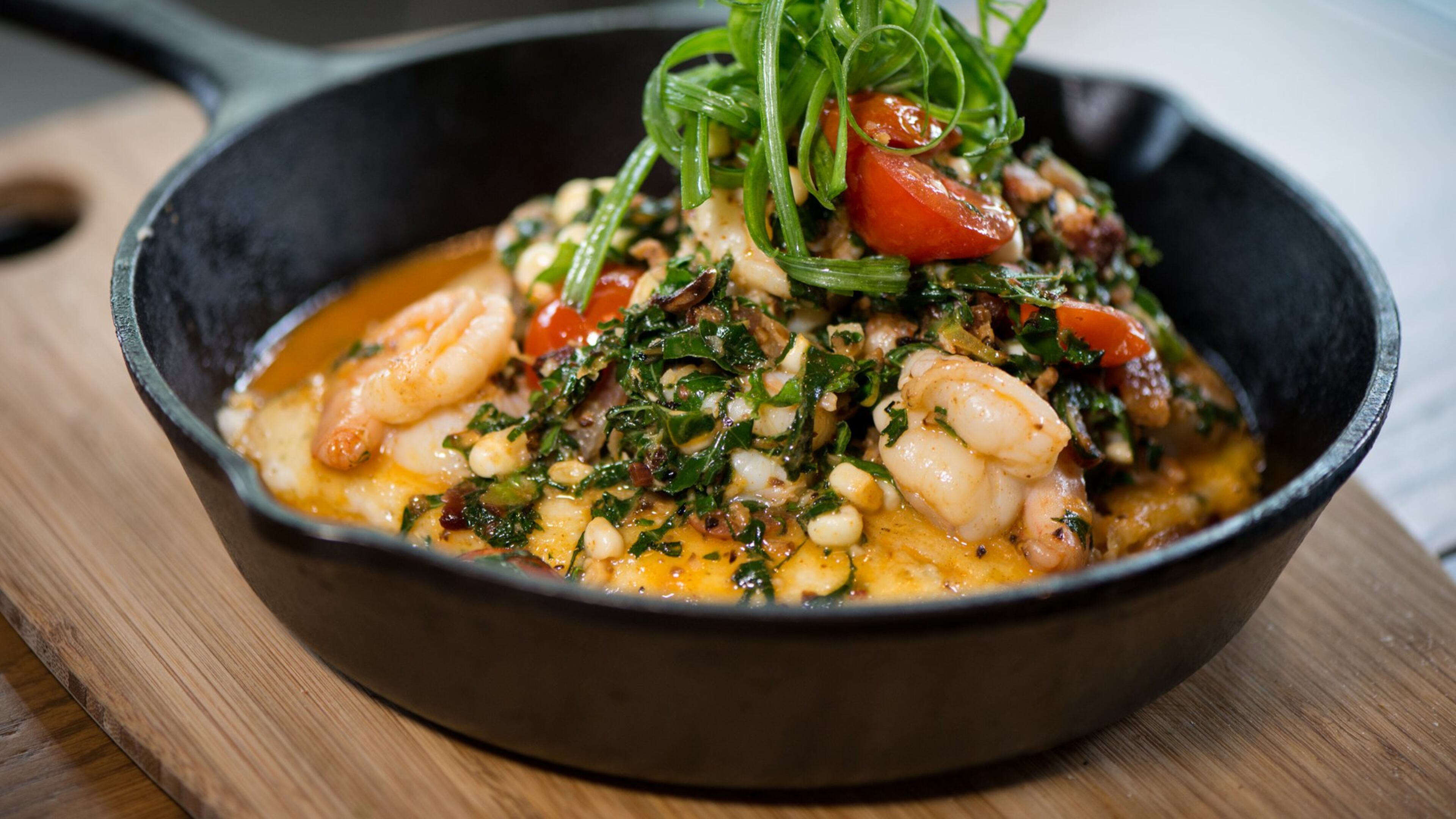 ublic School 404 Shrimp and Grits with smoky bacon and greens, blistered tomatoes, grilled corn, and beer-blanc sauce. Photo credit- Mia Yakel.