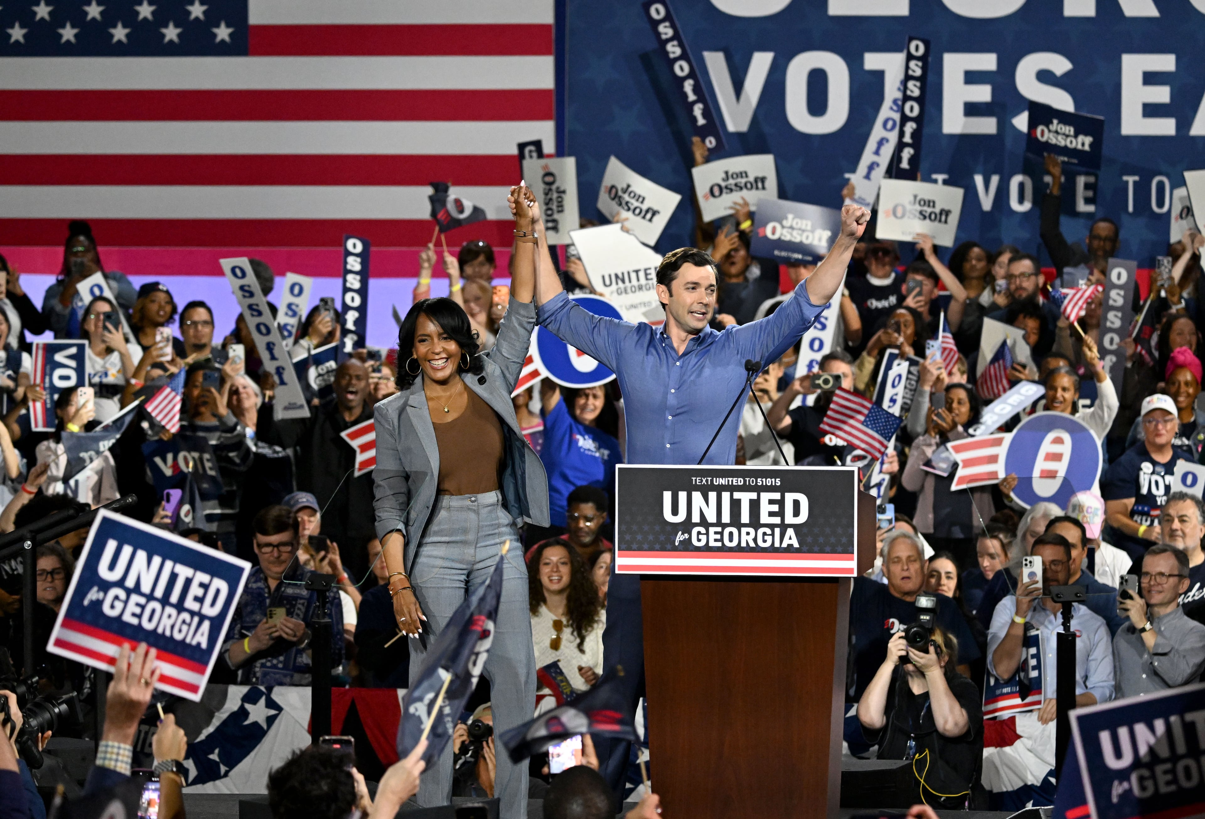Democratic gubernatorial candidate Keisha Lance Bottoms (left) and Democratic U.S. Sen. Jon Ossoff wave to supporters during a campaign rally at the Cobb County Convention Center on Saturday, Oct. 17, 2026, in Atlanta. (Hyosub Shin/AJC)