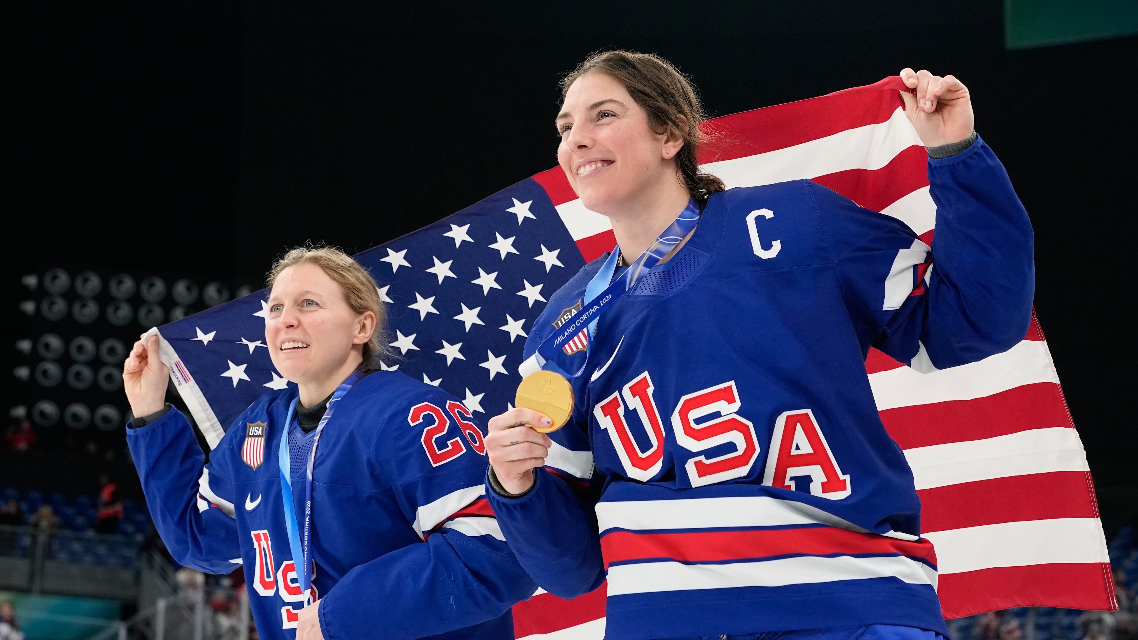 United States' Kendall Coyne, left, and United States' Hilary Knight celebrate after victory ceremony for women's ice hockey at the 2026 Winter Olympics, in Milan, Italy, Thursday, Feb. 19, 2026. (AP Photo/Hassan Ammar)