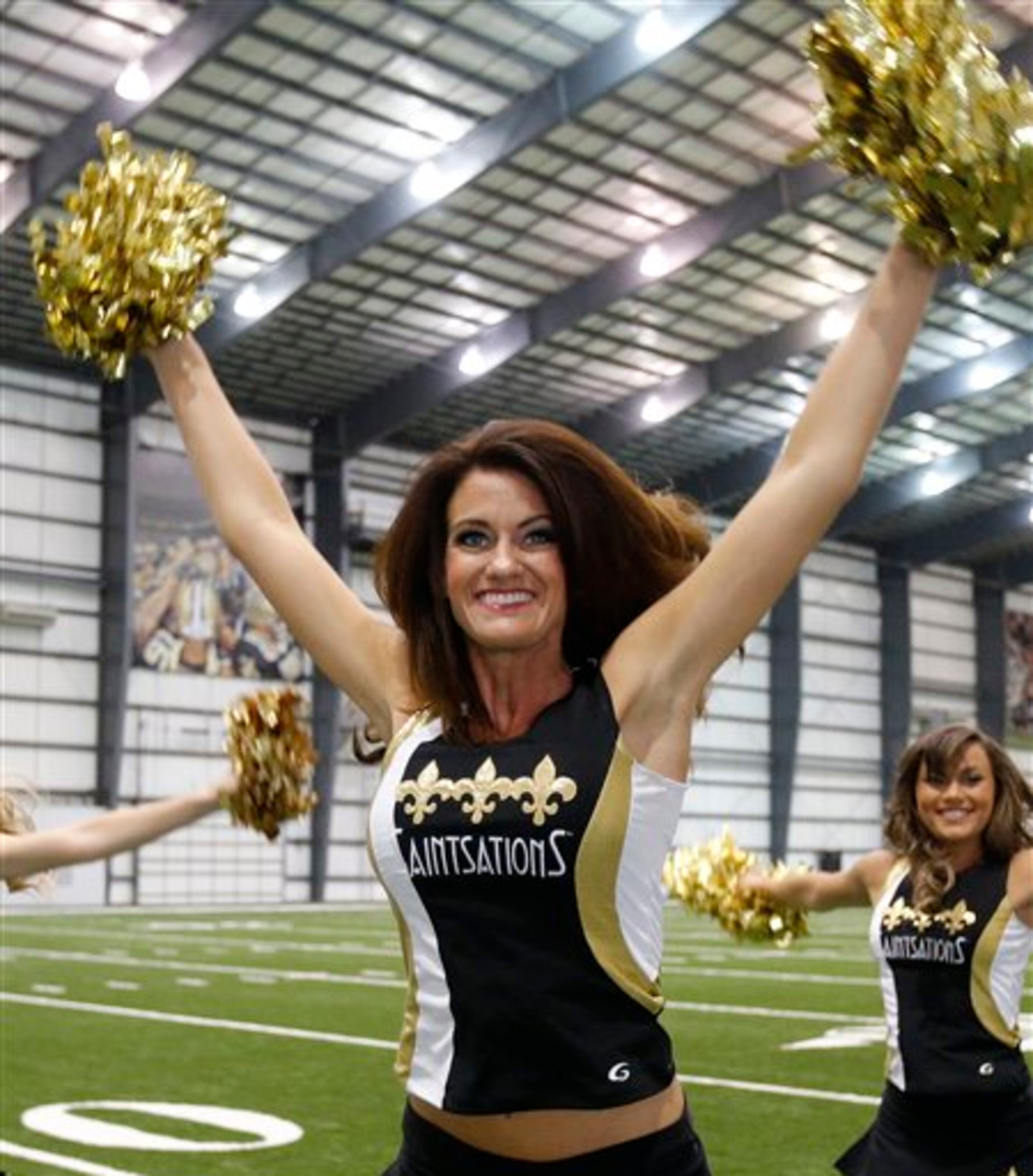 New Orleans Saints Saintsation Kriste Lewis performs during a photo shoot at the NFL football team's training facility in Metairie, La., Wednesday, July 16, 2014. Lewis is one of only two NFL cheerleaders in her 40s. The other dancer is 45-year-old Laura Vikmanis, who has been with the Cincinnati Bengals dance team, the Ben-Gals, since making the squad at age 40. (AP Photo/Bill Haber)